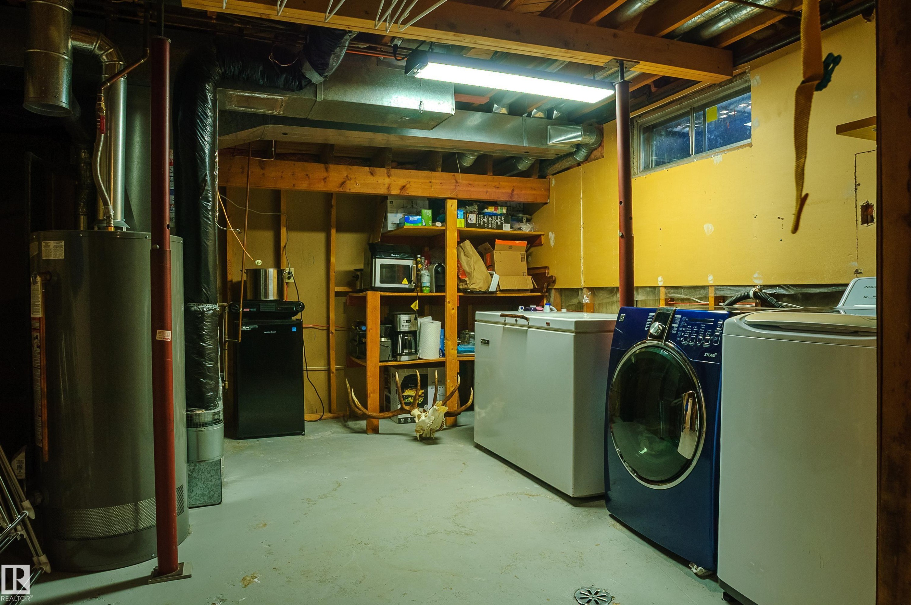 Utility room featuring a water heater, visible HVAC ductwork, and exposed ceiling joists - 58 Lodgepole Crescent, St. Albert, AB