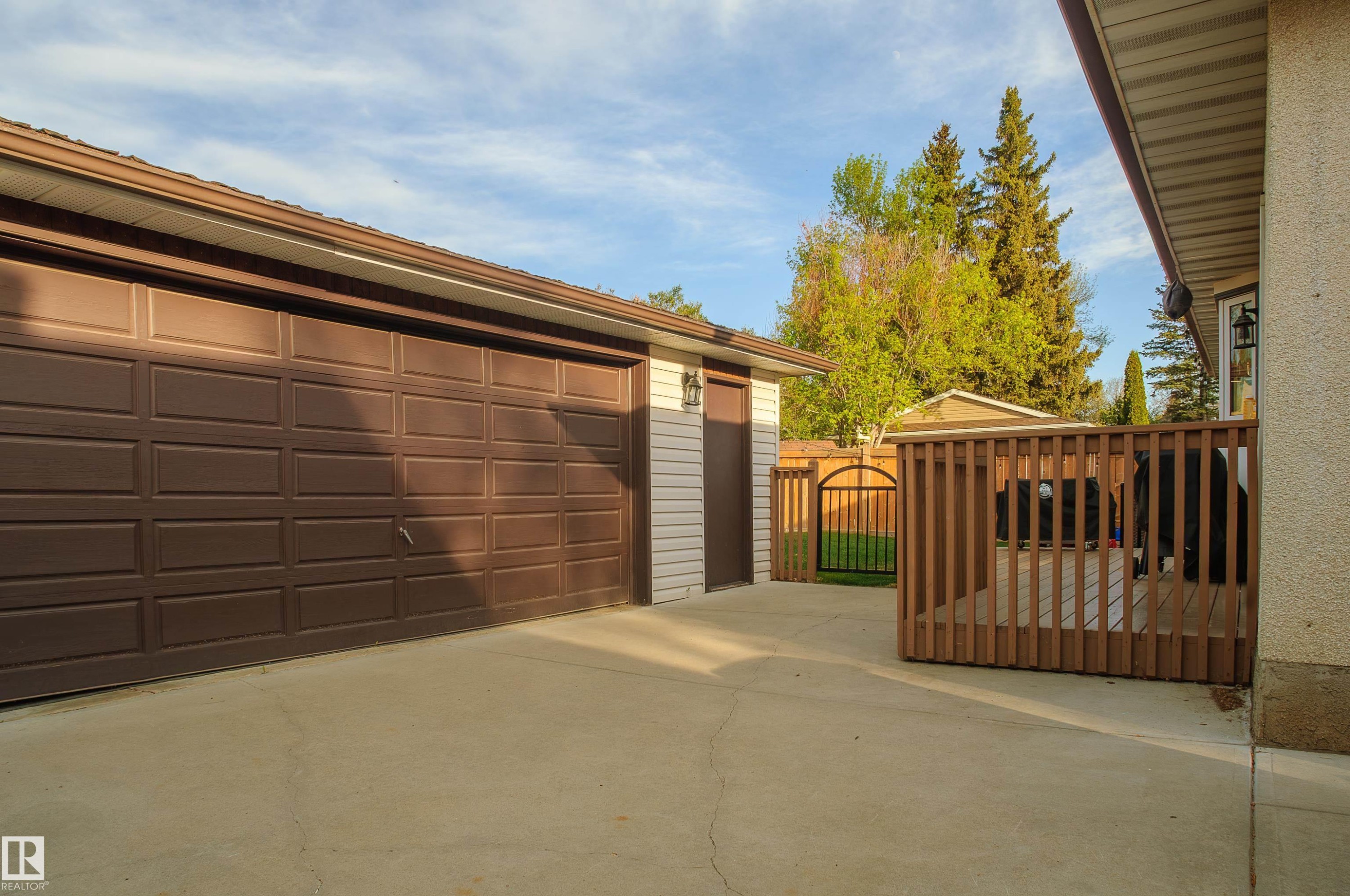 Two-car garage with panel-style doors and concrete driveway - 58 Lodgepole Crescent, St. Albert, AB