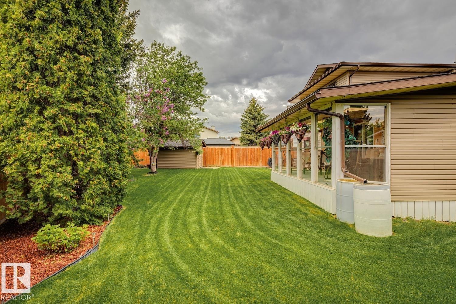 Expansive green lawn with striped mowing pattern - 15804 80 Street, Edmonton, AB