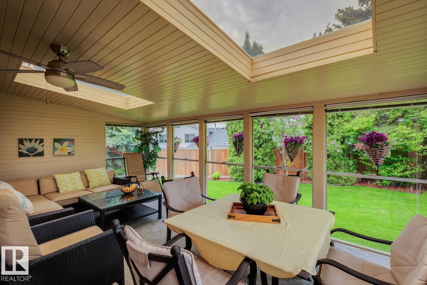 Enclosed patio space featuring a slatted ceiling, skylight, and ceiling fan - 15804 80 Street, Edmonton, AB