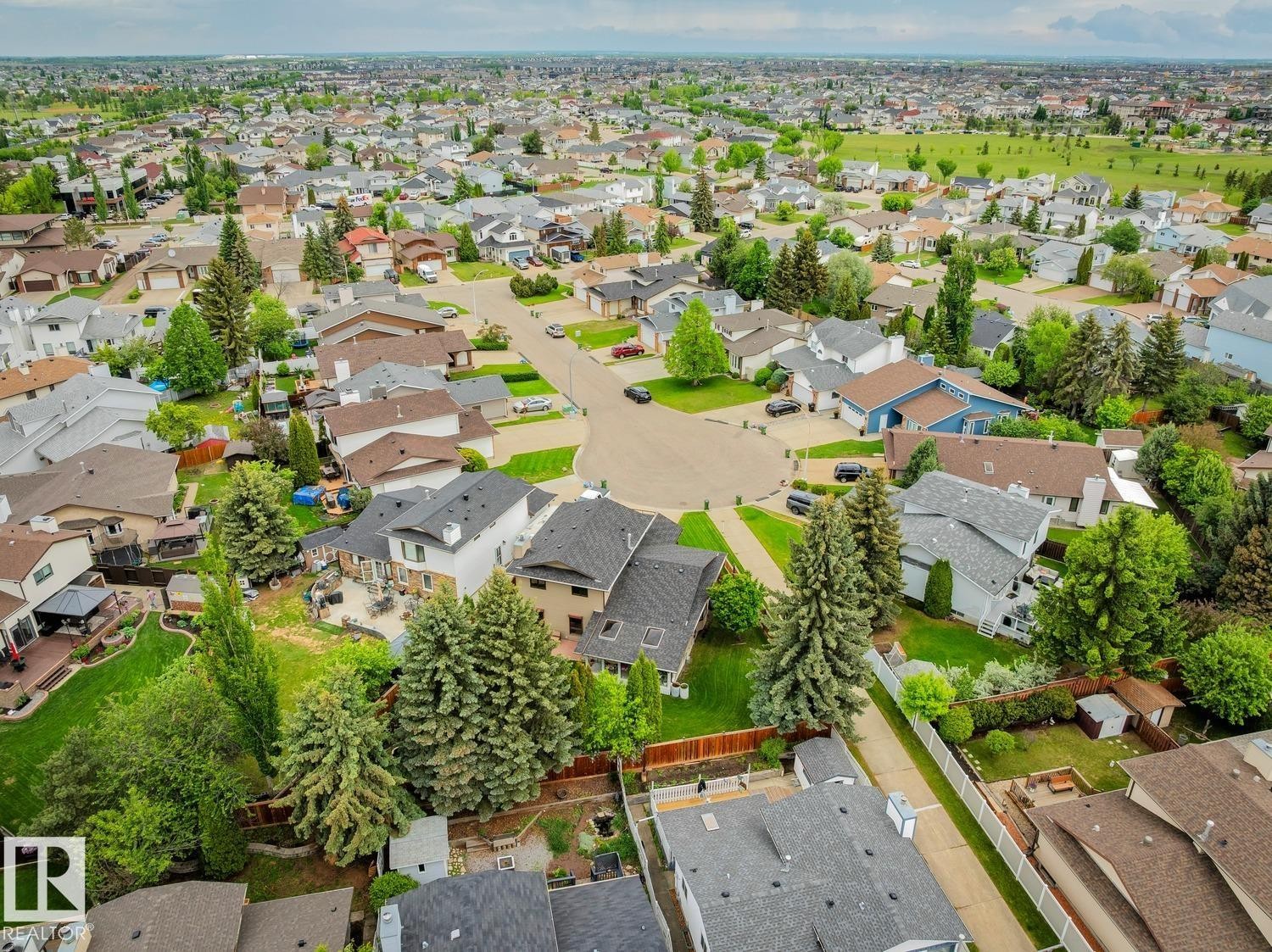 Aerial perspective showcasing a residential area with varied home styles and mature landscaping - 15804 80 Street, Edmonton, AB