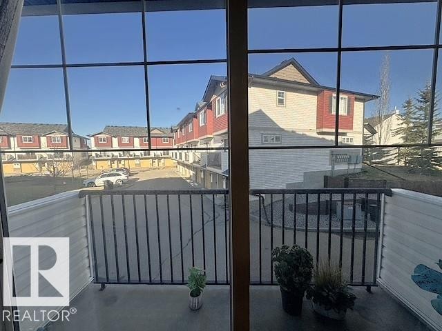 Private balcony with black metal railings and concrete flooring - #13 3751 12 Street, Edmonton, AB