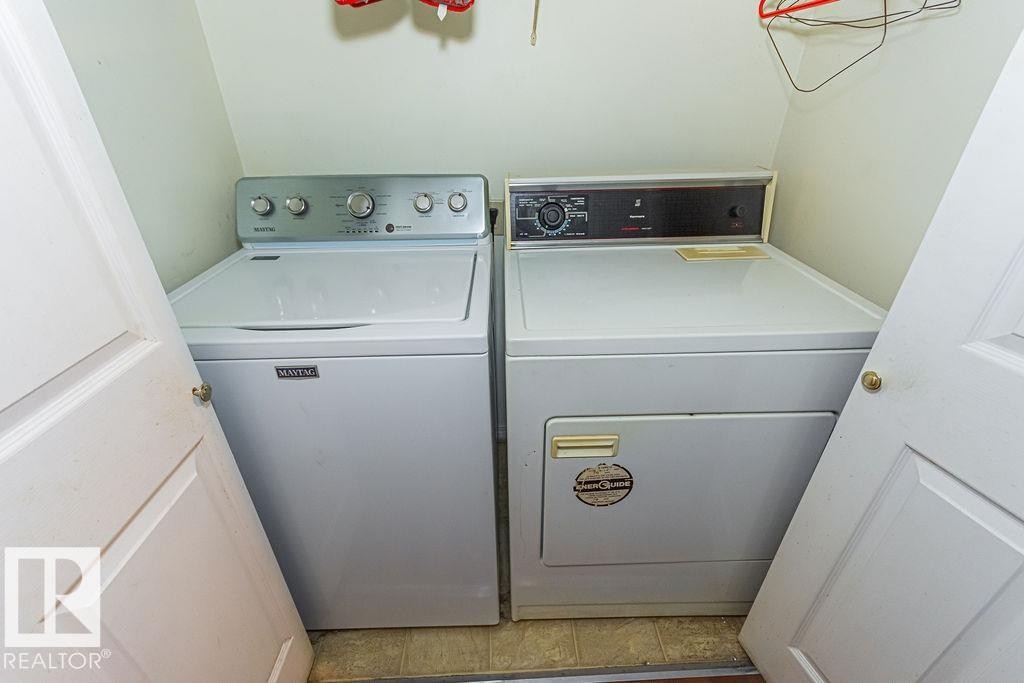 Dedicated laundry area featuring a white top-load washing machine and a white electric dryer - 6 3819 76 Street, Edmonton, AB