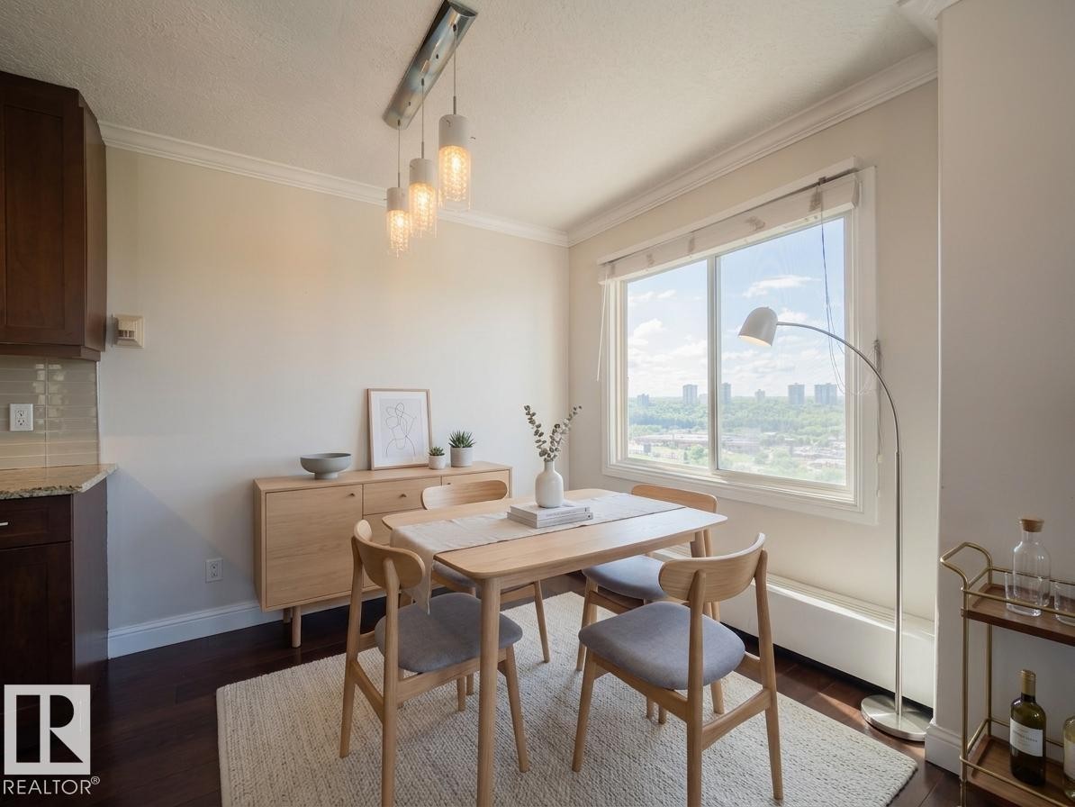 Bright dining area featuring a large window, dark wood-finish flooring, a contemporary linear pendant light, and crown molding - #Ph4 9725 106 St Nw, Edmonton, AB - Indoor Photo Showing Dining Room