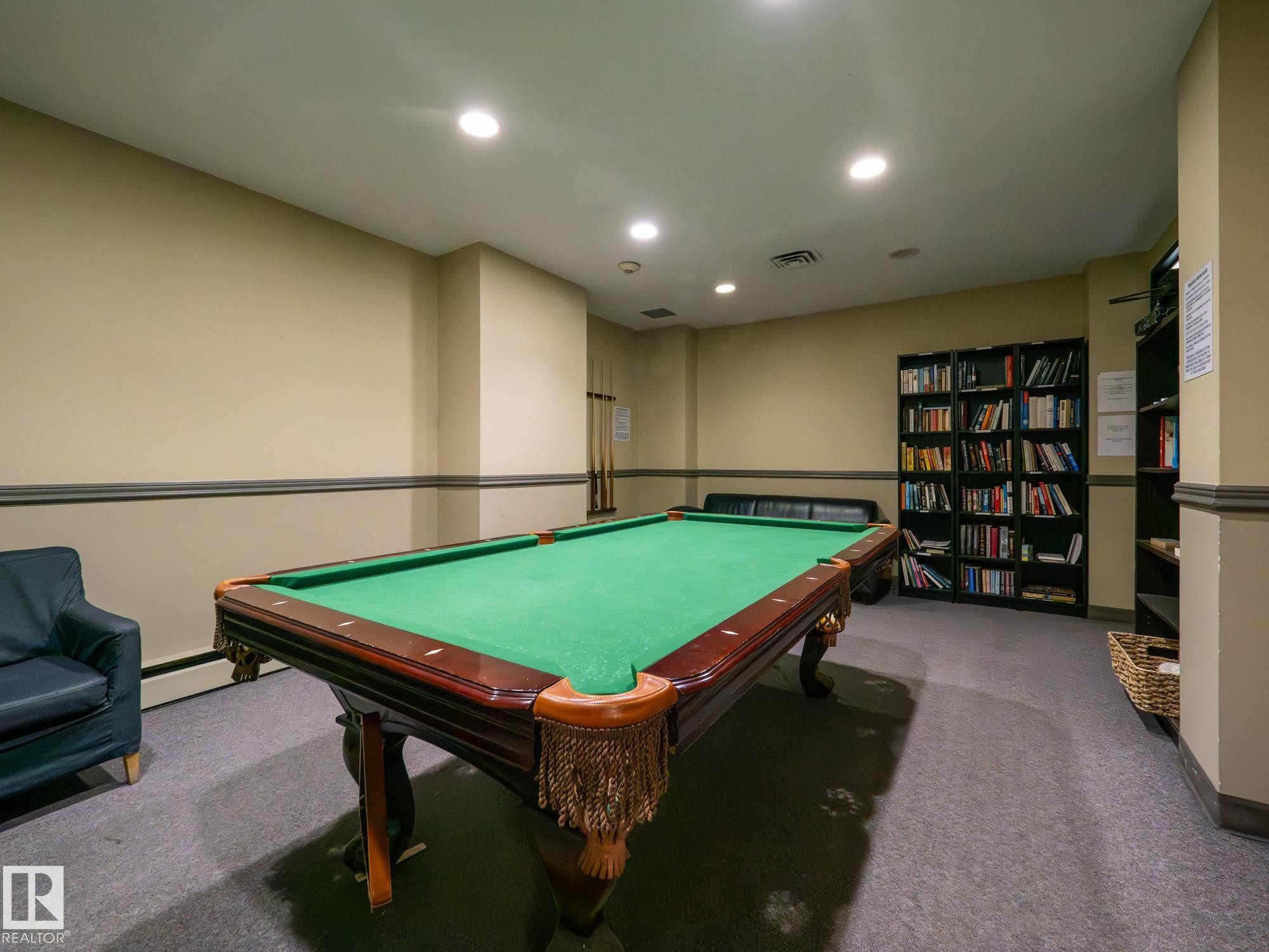 Recreation room featuring a billiard table with green felt and dark wood construction, recessed ceiling lighting, and built-in shelving - #Ph4 9725 106 St Nw, Edmonton, AB - Indoor Photo Showing Other Room