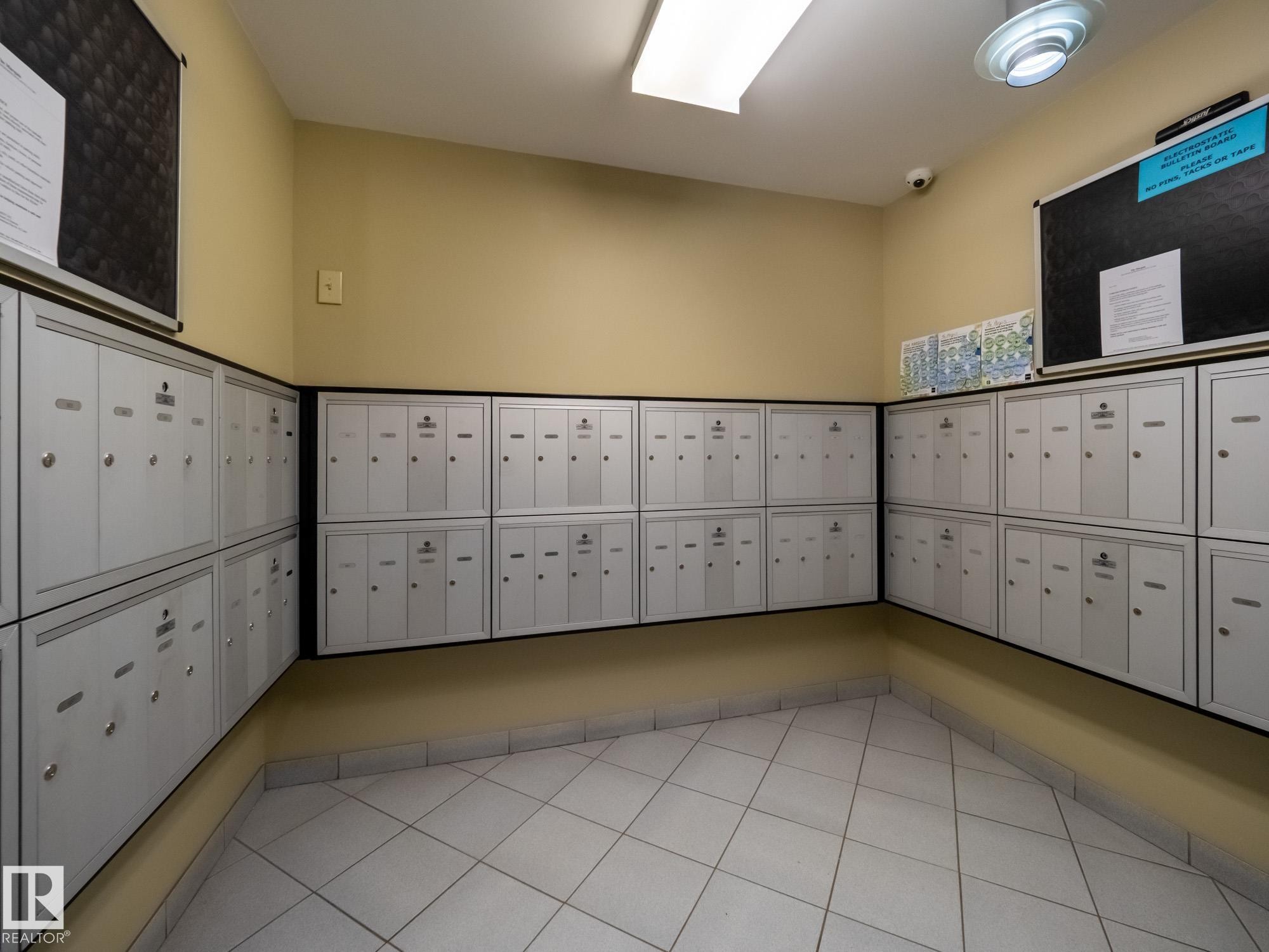 Centralized mailroom featuring individual mailboxes - #Ph4 9725 106 St Nw, Edmonton, AB - Indoor Photo Showing Other Room