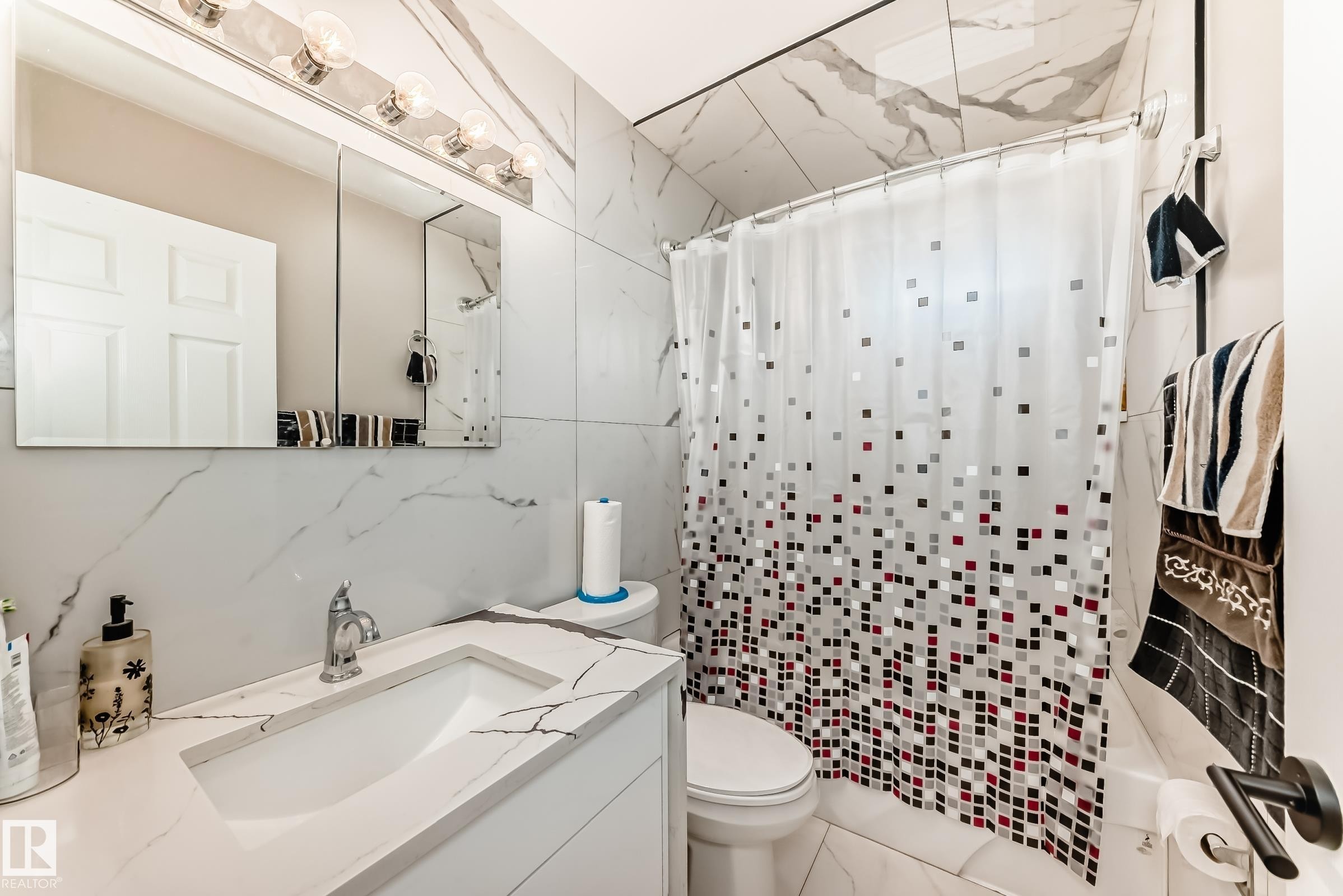 Bathroom featuring a white vanity with an integrated rectangular sink and chrome faucet - 3843 47 Street Nw, Edmonton, AB - Indoor Photo Showing Bathroom