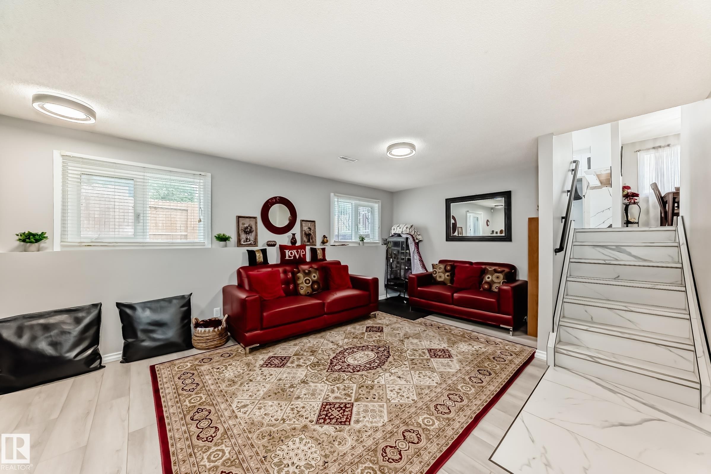 Spacious recreational room featuring light wood-finish flooring, recessed lighting, and multiple windows - 3843 47 Street Nw, Edmonton, AB - Indoor Photo Showing Living Room