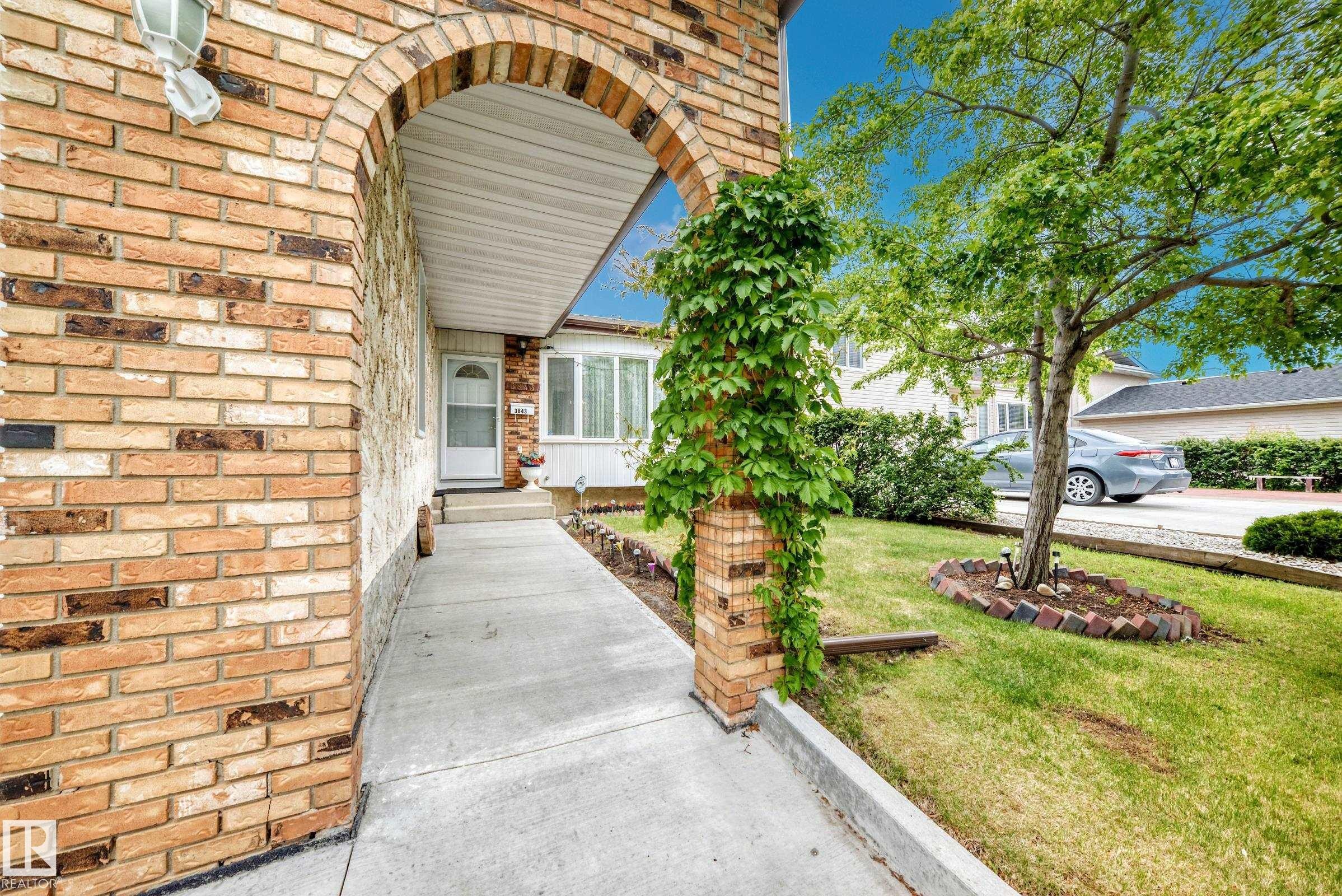 Brick exterior archway entrance featuring a concrete walkway - 3843 47 Street Nw, Edmonton, AB - Outdoor