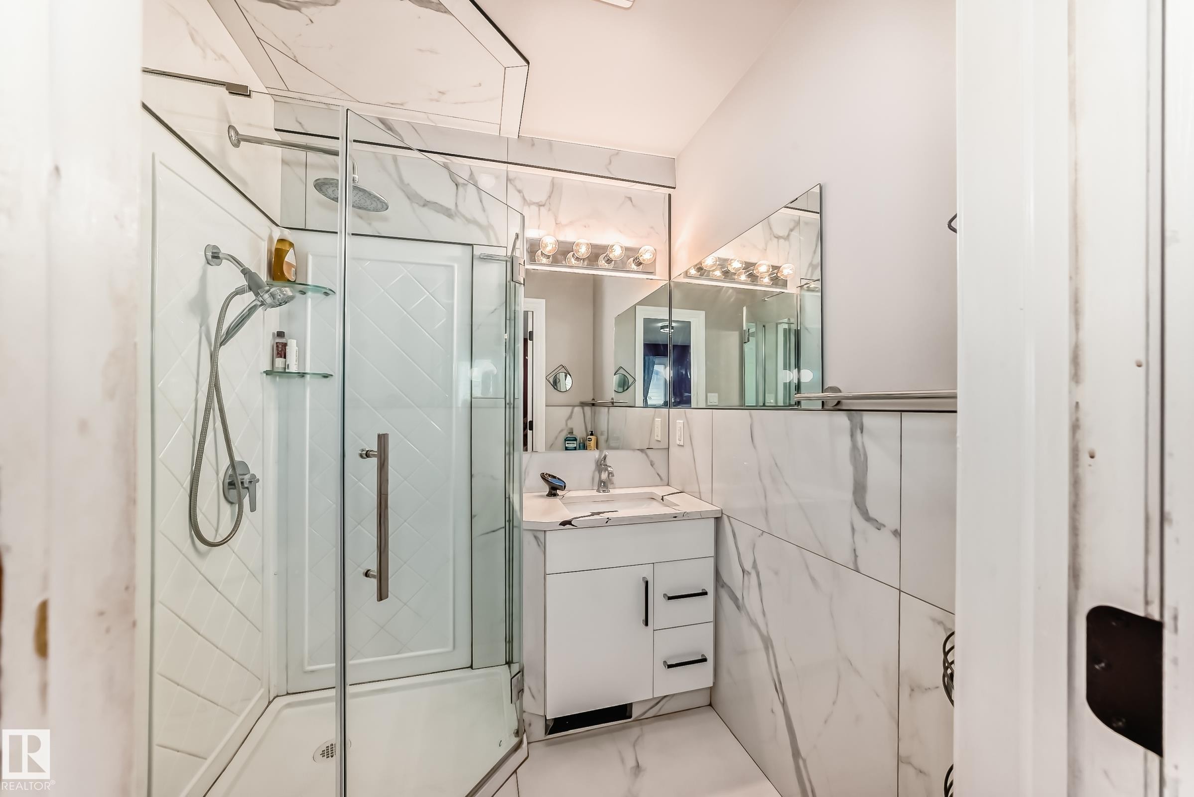 Glass-enclosed shower with a handheld shower fixture - 3843 47 Street Nw, Edmonton, AB - Indoor Photo Showing Bathroom