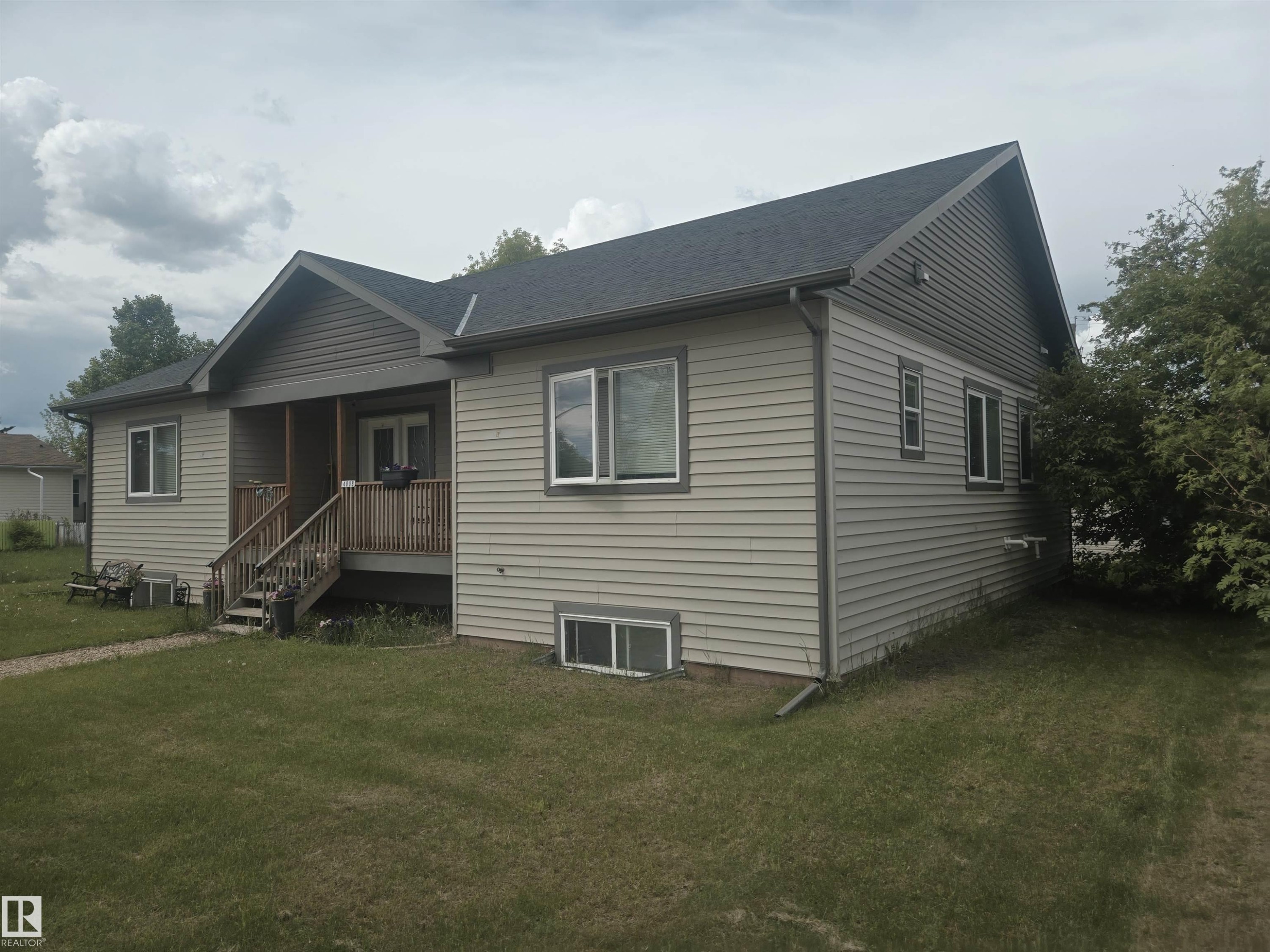 Single-story residence featuring light-colored horizontal siding and a dark shingled roof - 4808 50 Avenue, Lamont, AB