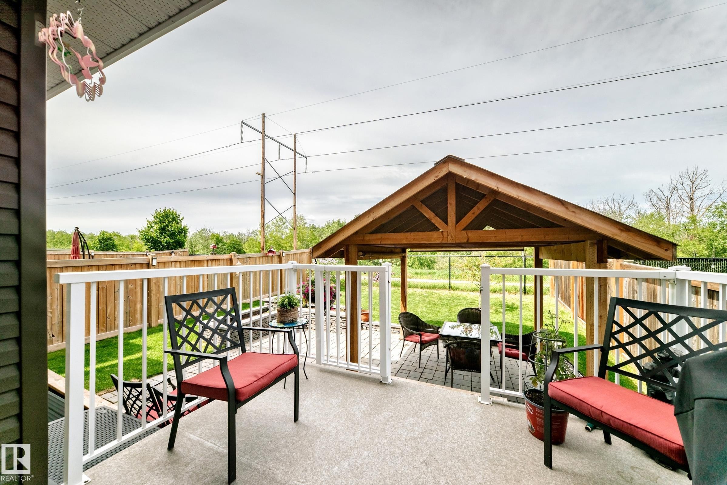 Spacious outdoor deck with white railings, a concrete surface, and a wooden gazebo - 3895 Robins Crescent Nw, Edmonton, AB - Outdoor With Deck Patio Veranda With Exterior