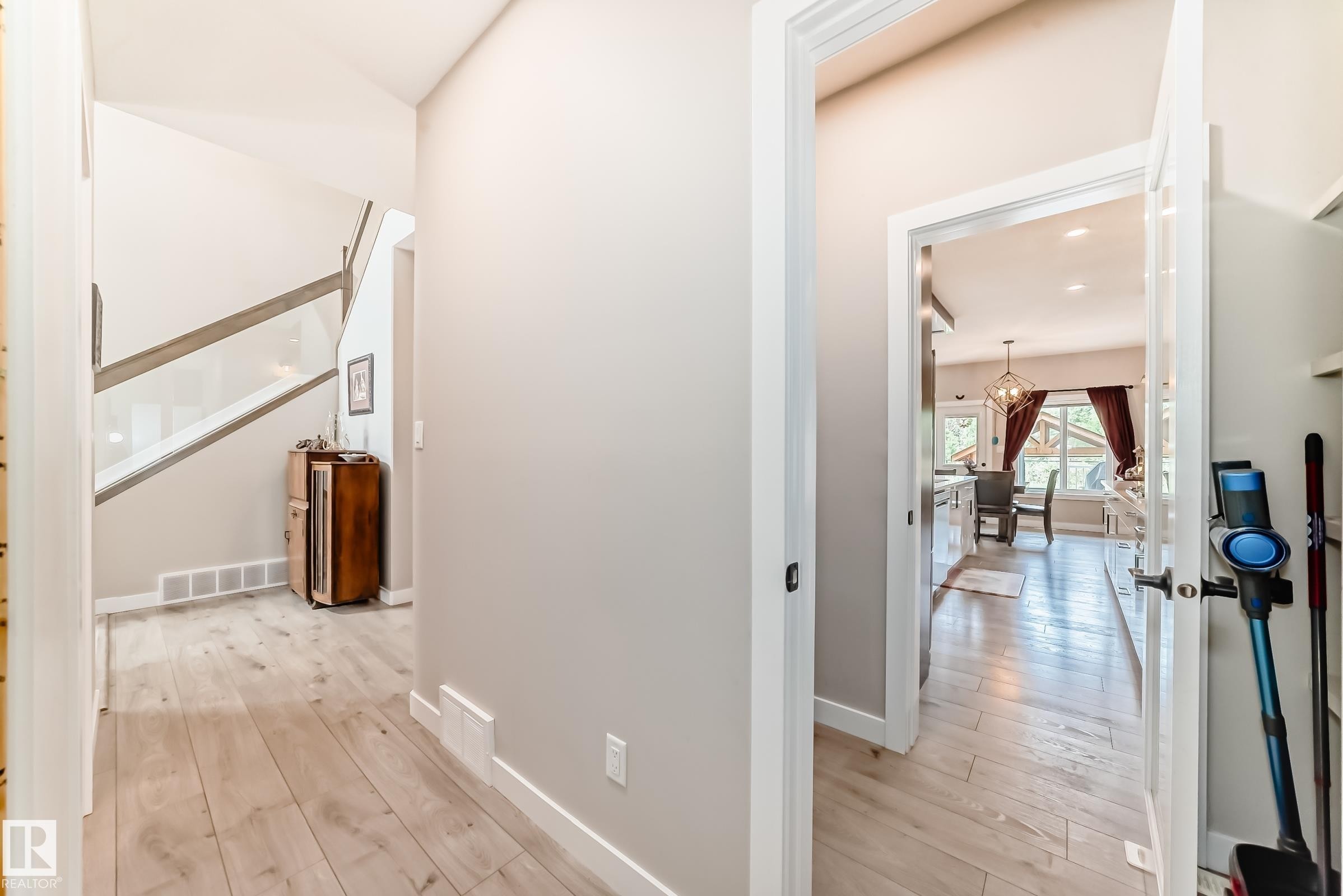 Hallway with wood-finish flooring, light neutral wall tones, and white baseboards - 3895 Robins Crescent Nw, Edmonton, AB - Indoor Photo Showing Other Room