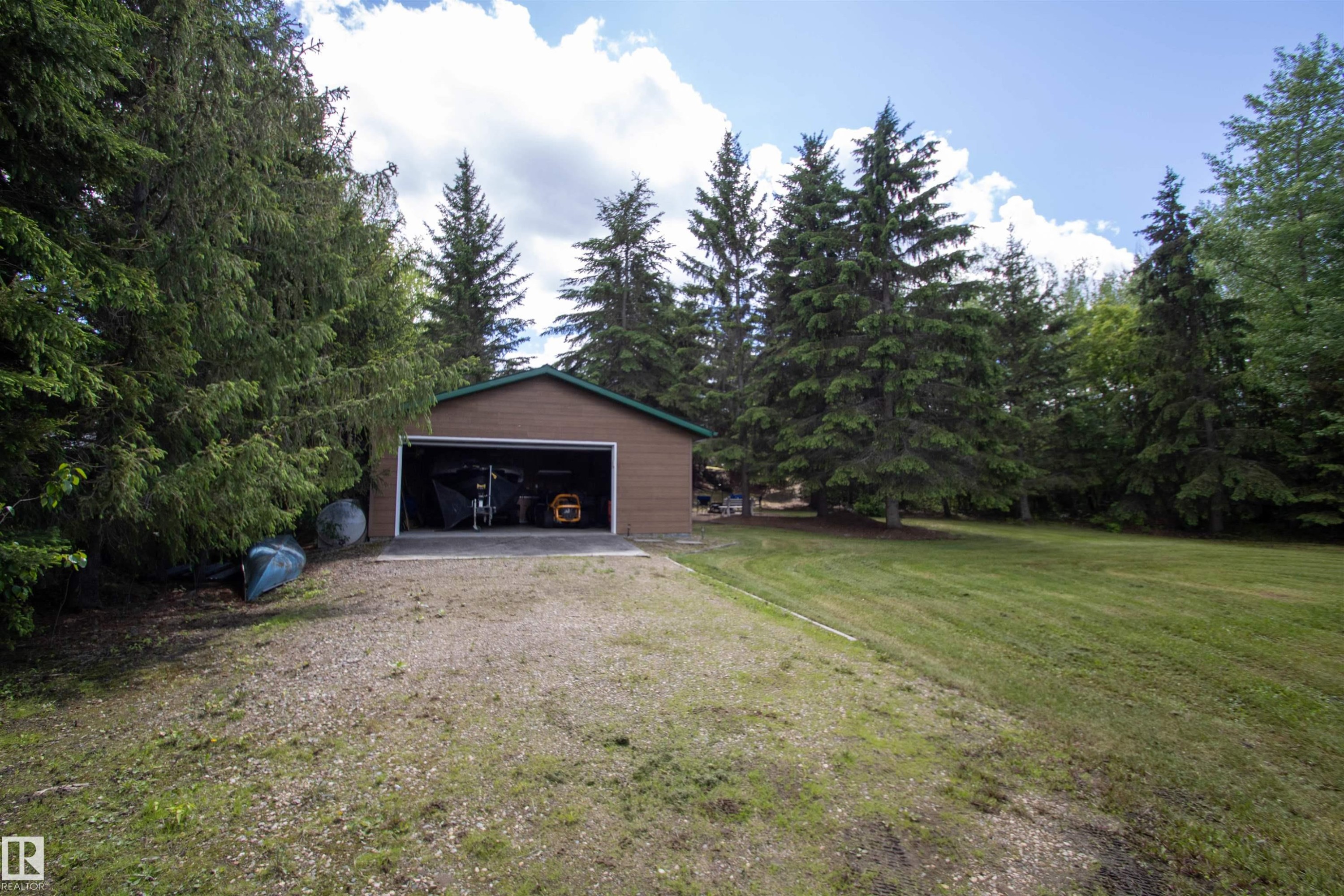 Detached two-car garage with brown siding and a dark green roof - 104 60201 Rng Rd 122, Rural St. Paul County, AB