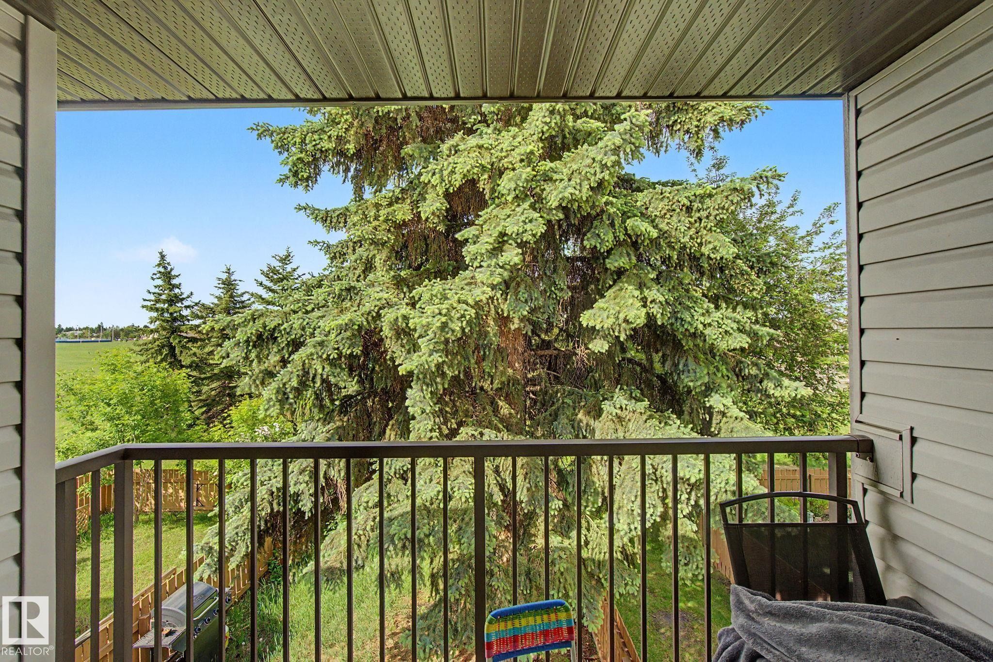 Balcony featuring metal railing, vinyl siding, and a soffit ceiling - #45 2020 105 St Nw, Edmonton, AB - Outdoor With Balcony With Exterior