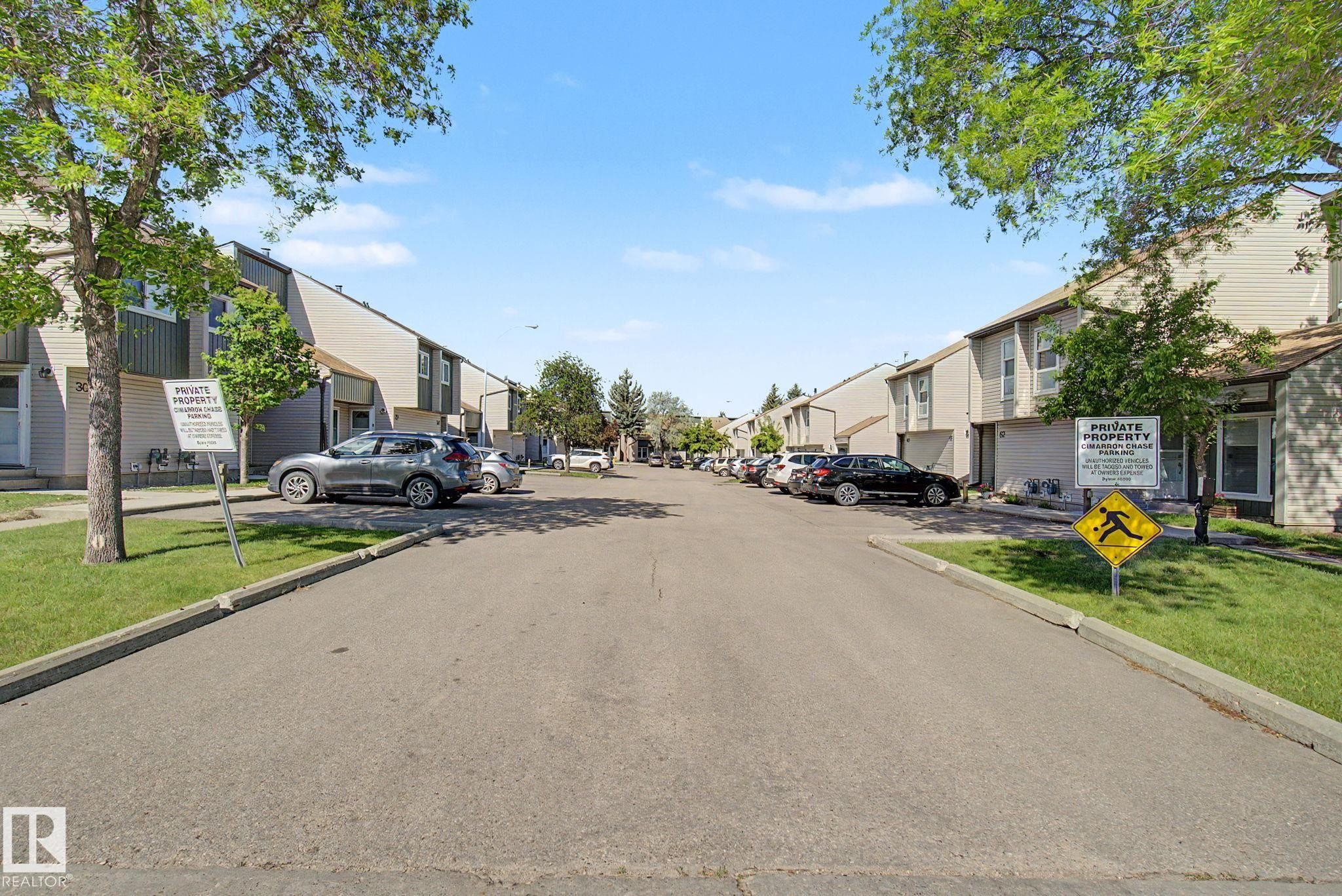 Townhome community featuring multi-level units with light-toned siding and dark trim accents - #45 2020 105 St Nw, Edmonton, AB - Outdoor