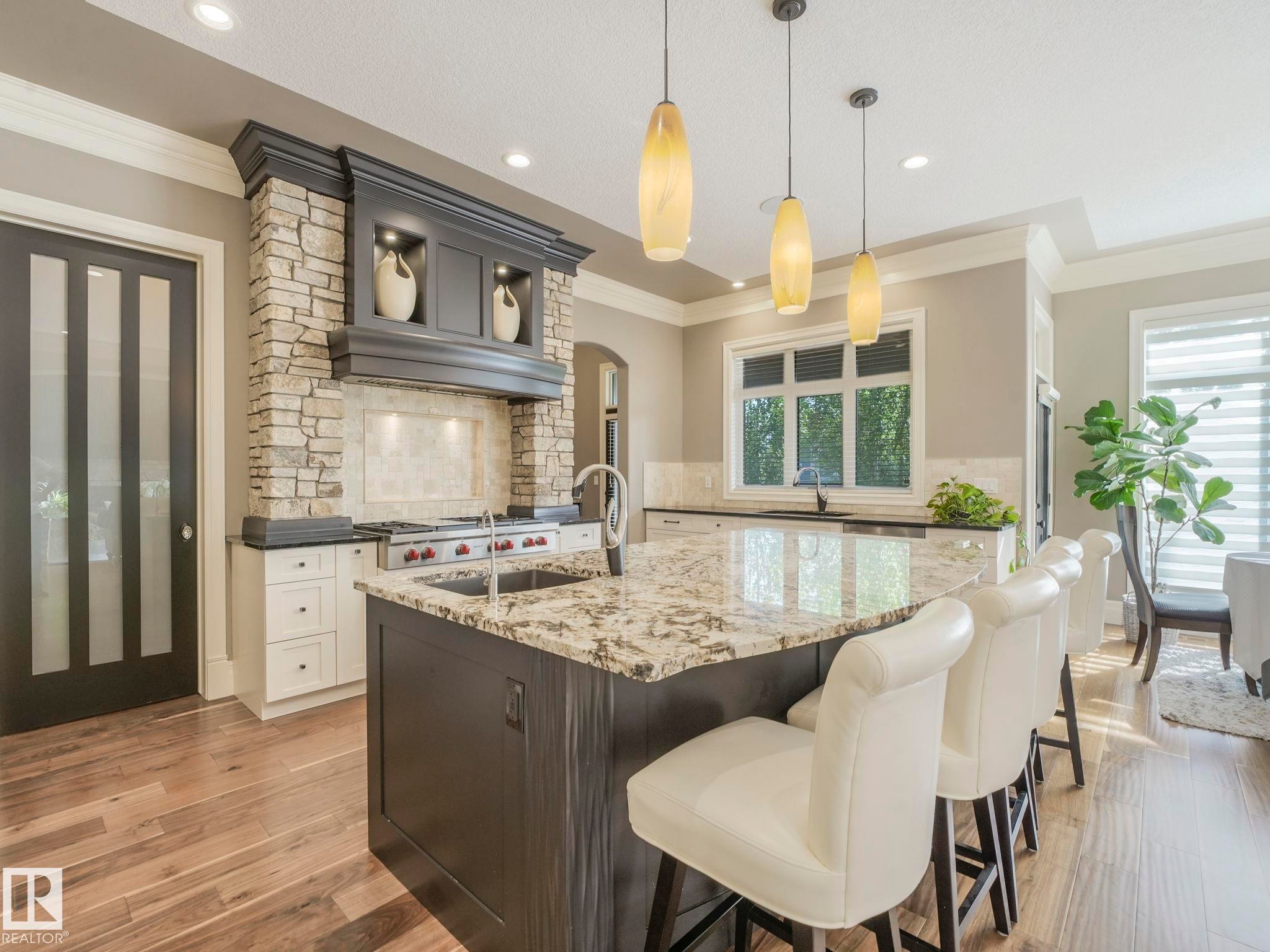 Spacious kitchen island featuring a granite countertop with integrated sink and bar seating - 2807 Wheaton Drive, Edmonton, AB