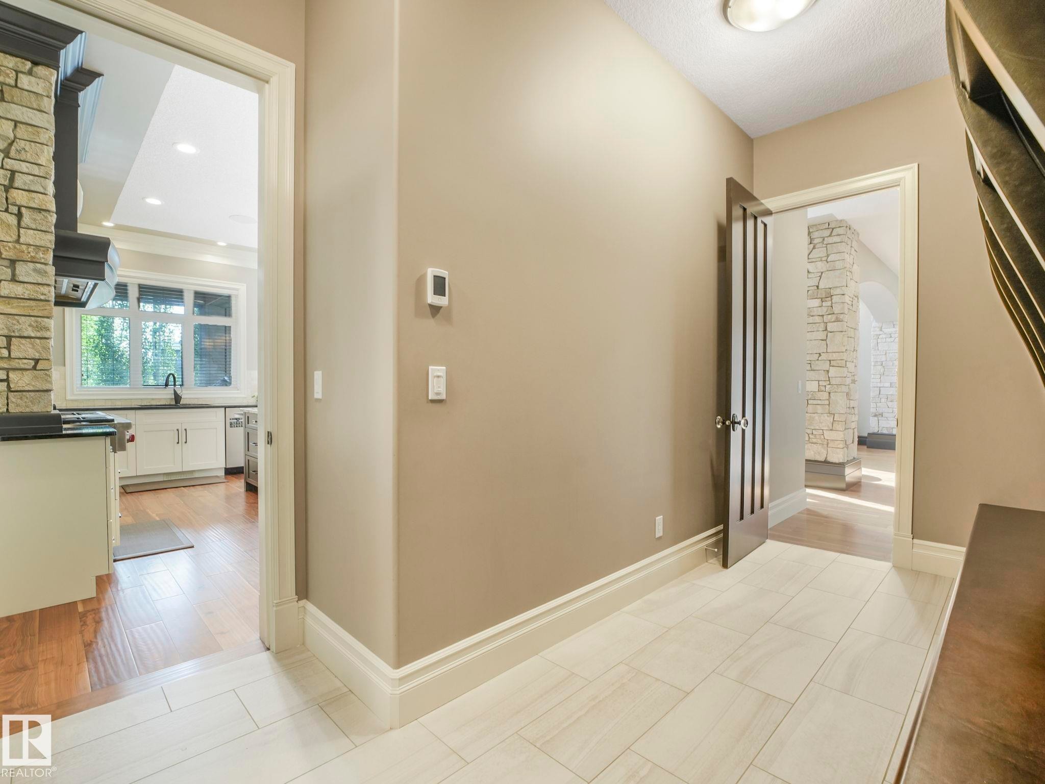 Entryway featuring light-toned tile flooring, neutral wall tones, and white trim - 2807 Wheaton Drive, Edmonton, AB