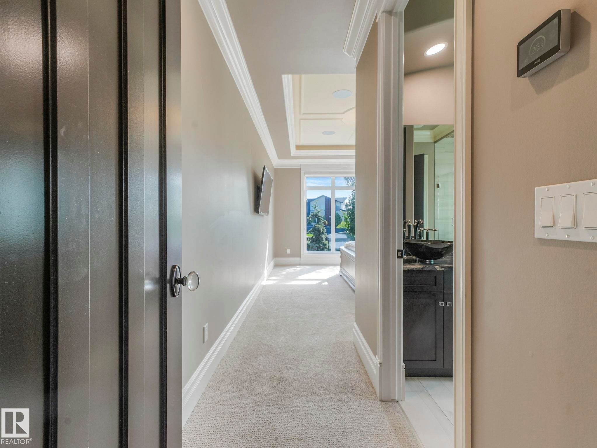 Hallway featuring crown molding, baseboards, and neutral wall tones - 2807 Wheaton Drive, Edmonton, AB
