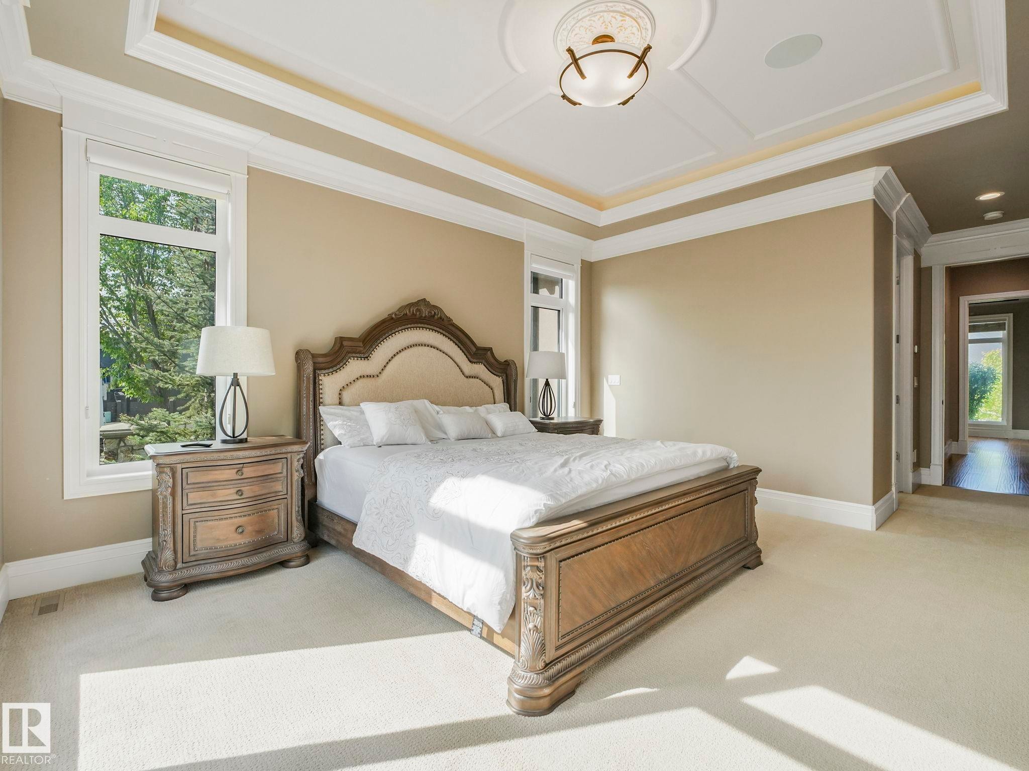 Bedroom featuring a coffered ceiling with a central medallion light fixture and recessed lighting, crown molding, and large windows - 2807 Wheaton Drive, Edmonton, AB