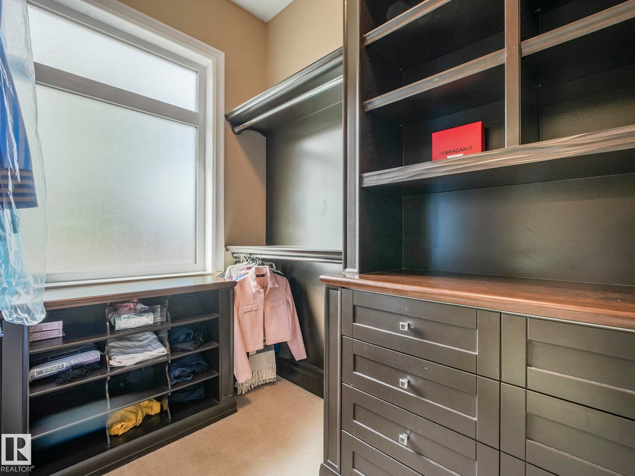 Custom built-in closet system featuring dark wood-finish cabinetry - 2807 Wheaton Drive, Edmonton, AB