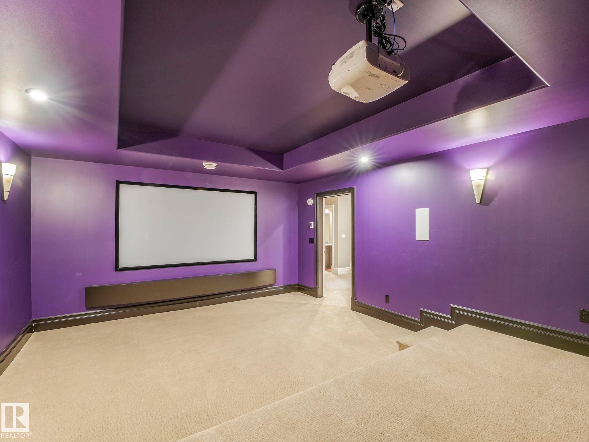 Dedicated media room featuring a large projection screen, mounted projector, recessed lighting, and wall sconces - 2807 Wheaton Drive, Edmonton, AB
