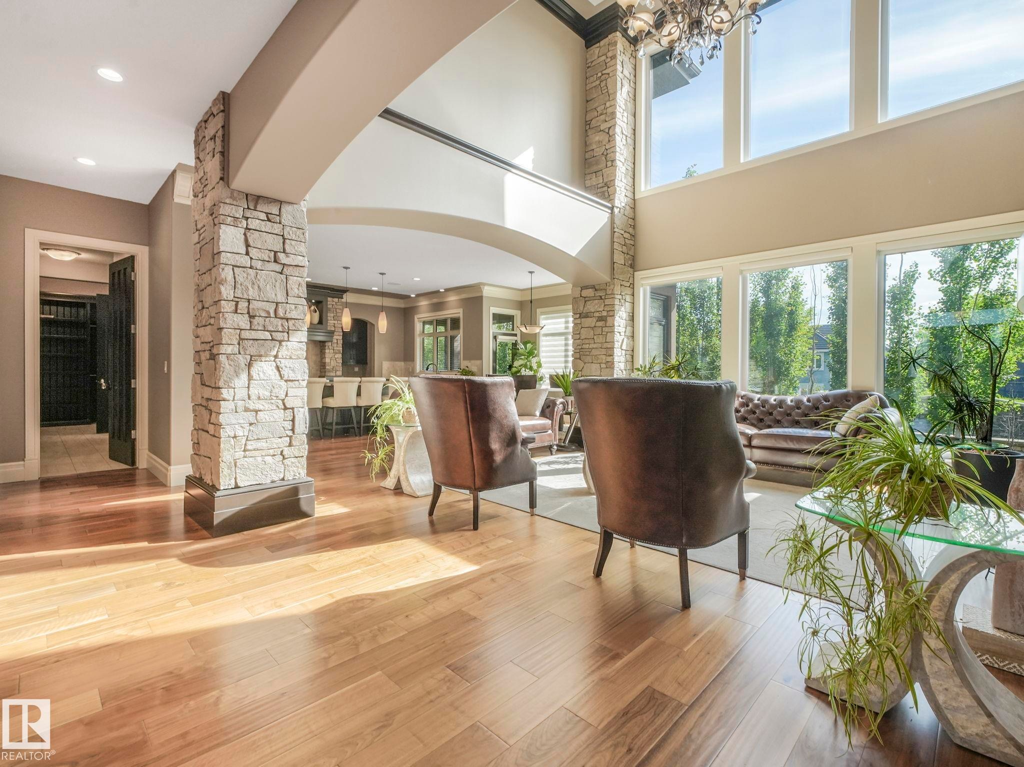 Grand entrance featuring stone columns, archways, and light wood-finish flooring - 2807 Wheaton Drive, Edmonton, AB