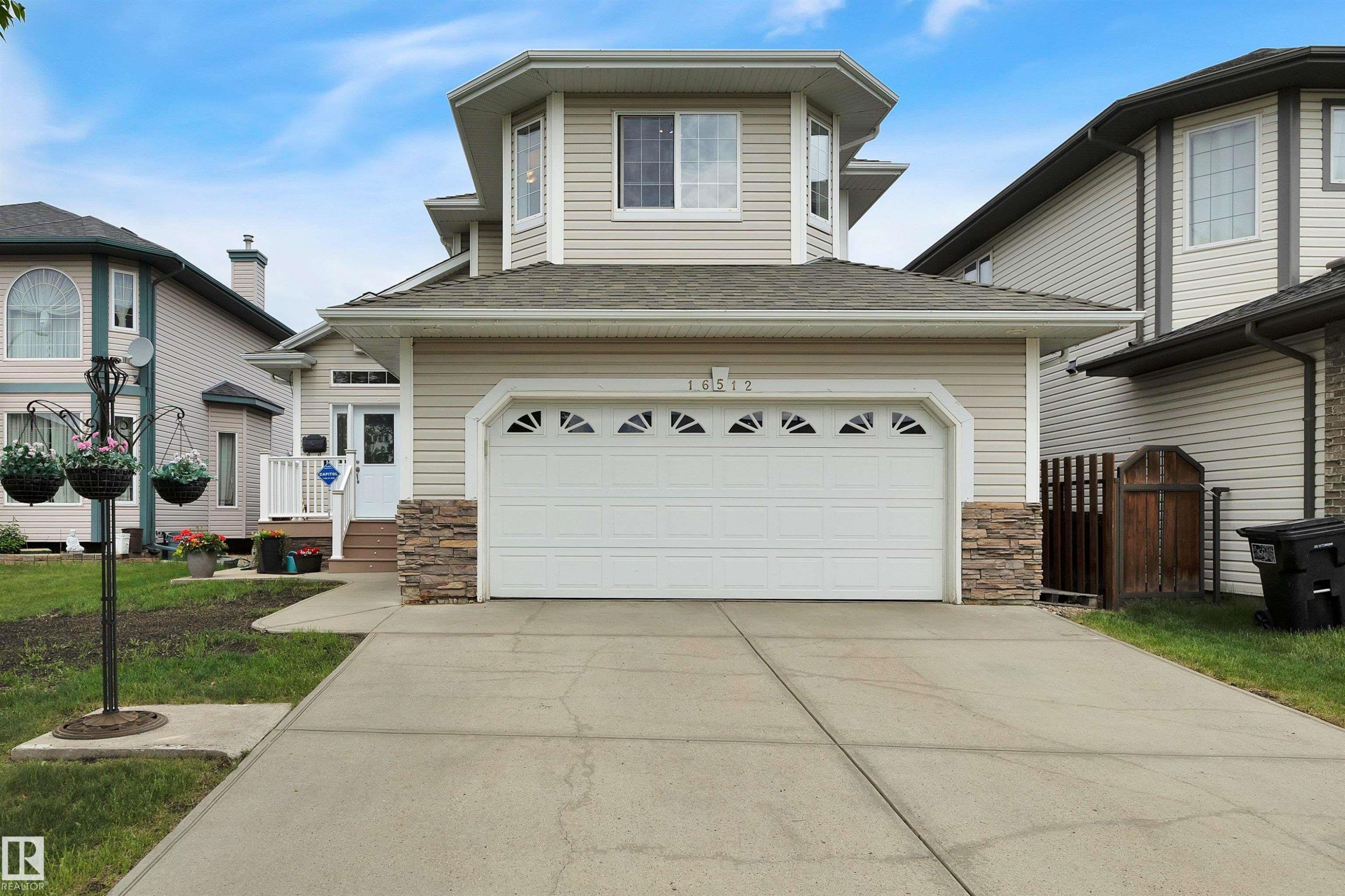 Two-story home with a light-colored siding exterior and a two-car garage - 16512 87 Street Nw, Edmonton, AB - Outdoor