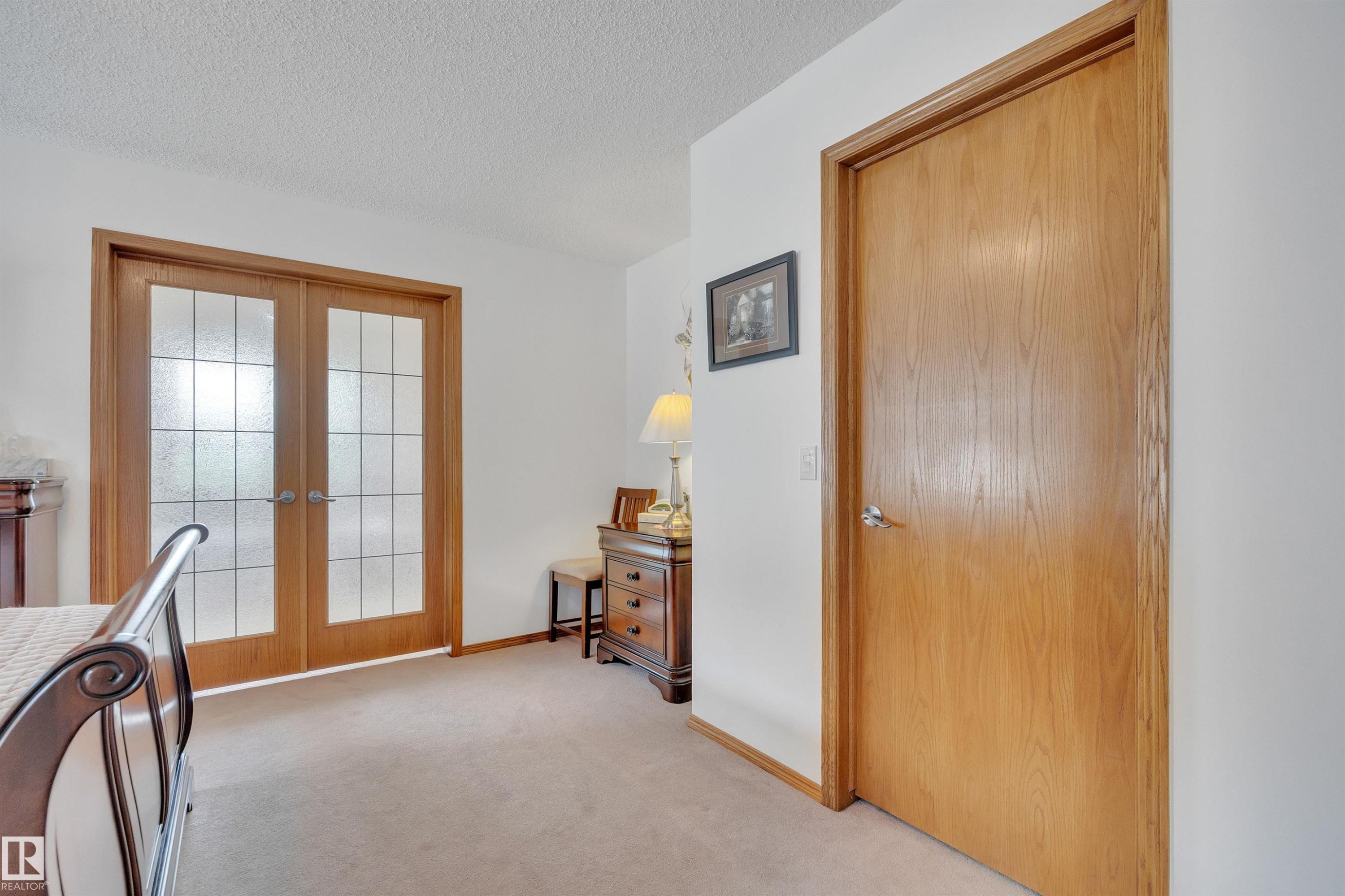 Double French doors with frosted glass panels and a solid wood door - 16512 87 Street Nw, Edmonton, AB - Indoor