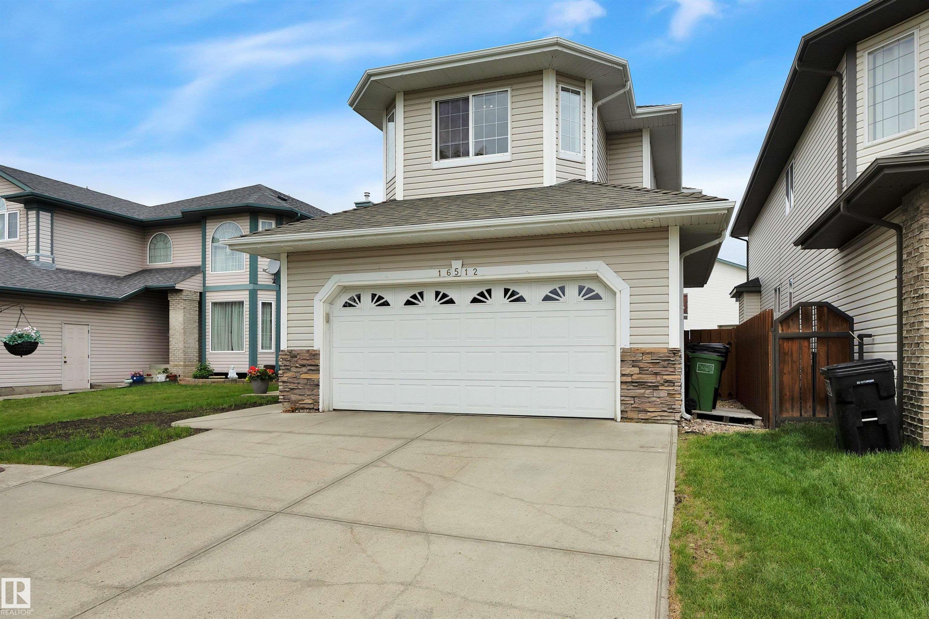 Two-story residence featuring light-toned horizontal siding and a stone-clad facade accent - 16512 87 Street Nw, Edmonton, AB - Outdoor