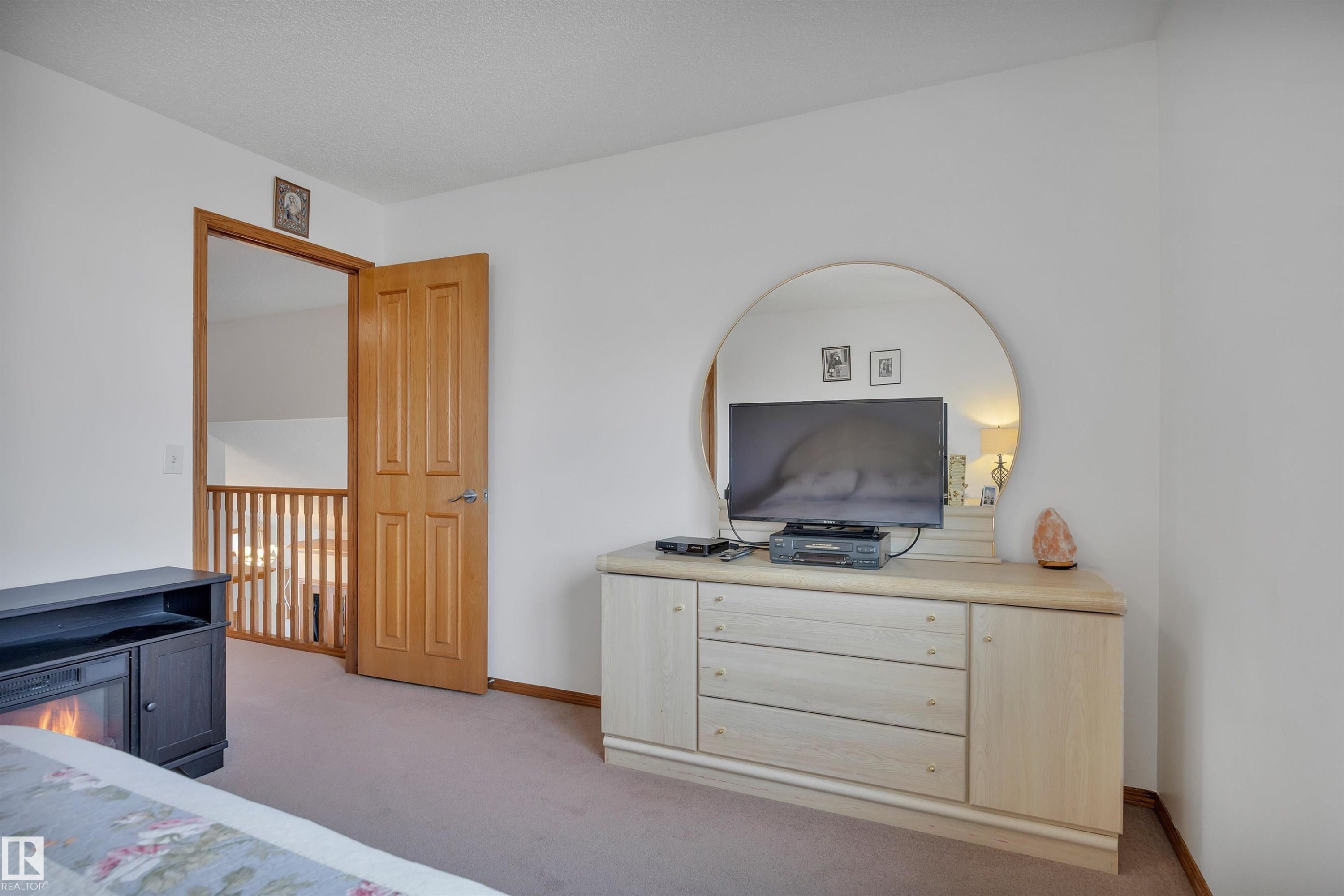 Interior space featuring light-colored walls and soft brown carpeting - 16512 87 Street Nw, Edmonton, AB - Indoor