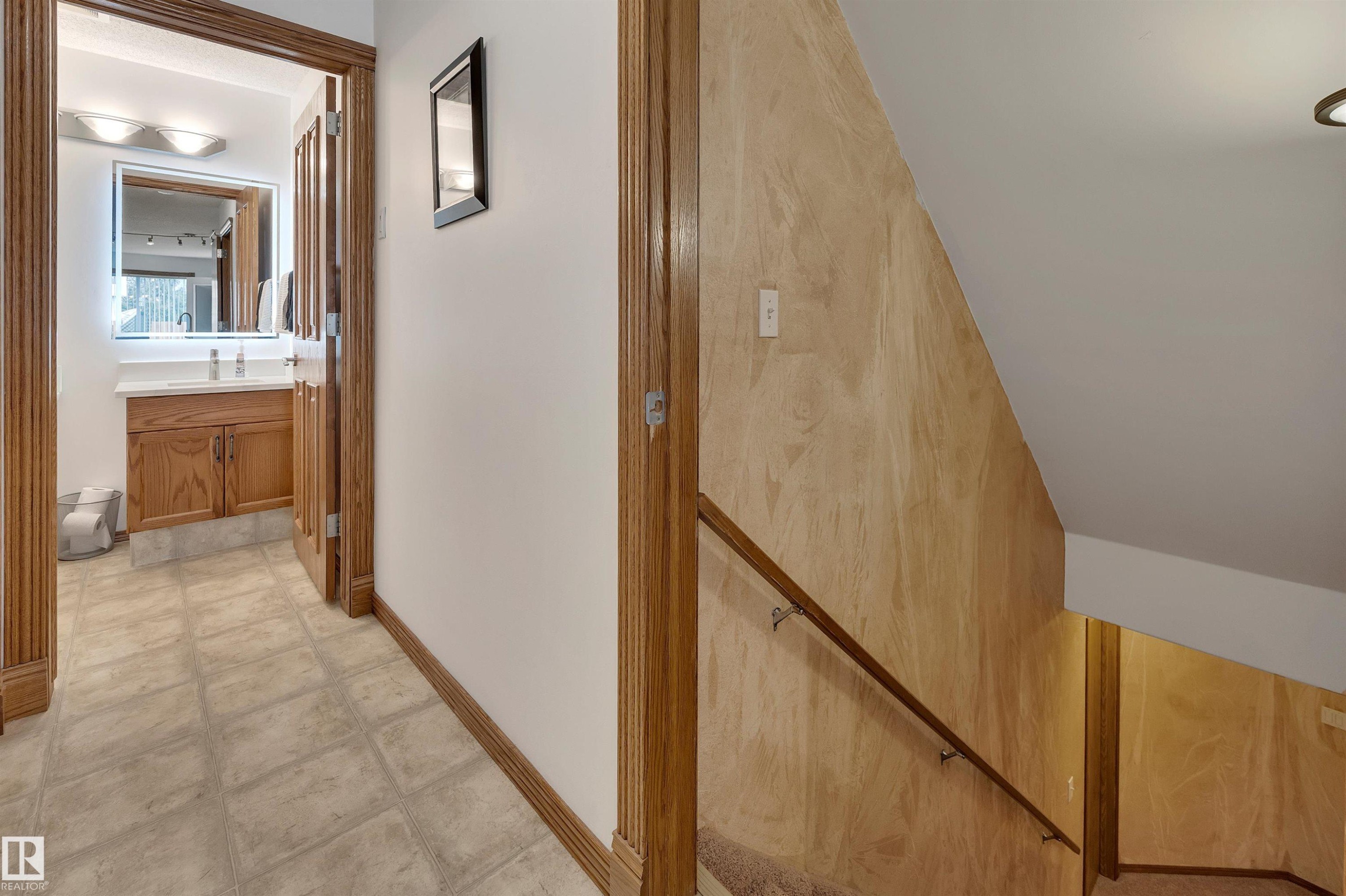Hallway featuring wood-finish trim and tile flooring - 16512 87 Street Nw, Edmonton, AB - Indoor Photo Showing Other Room