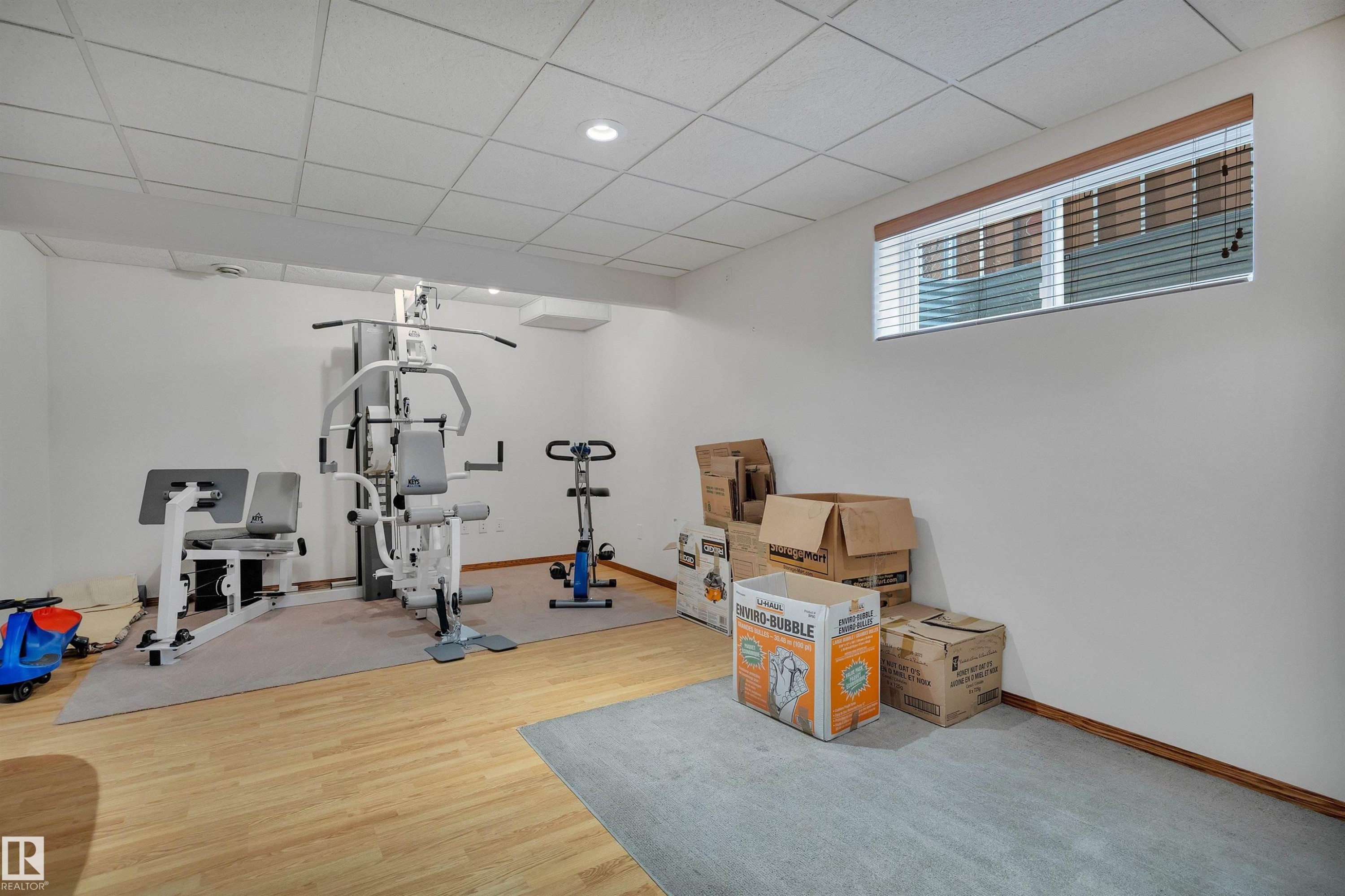 Lower-level bonus room with light wood-finish flooring, recessed lighting, and a drop ceiling - 16512 87 Street Nw, Edmonton, AB - Indoor