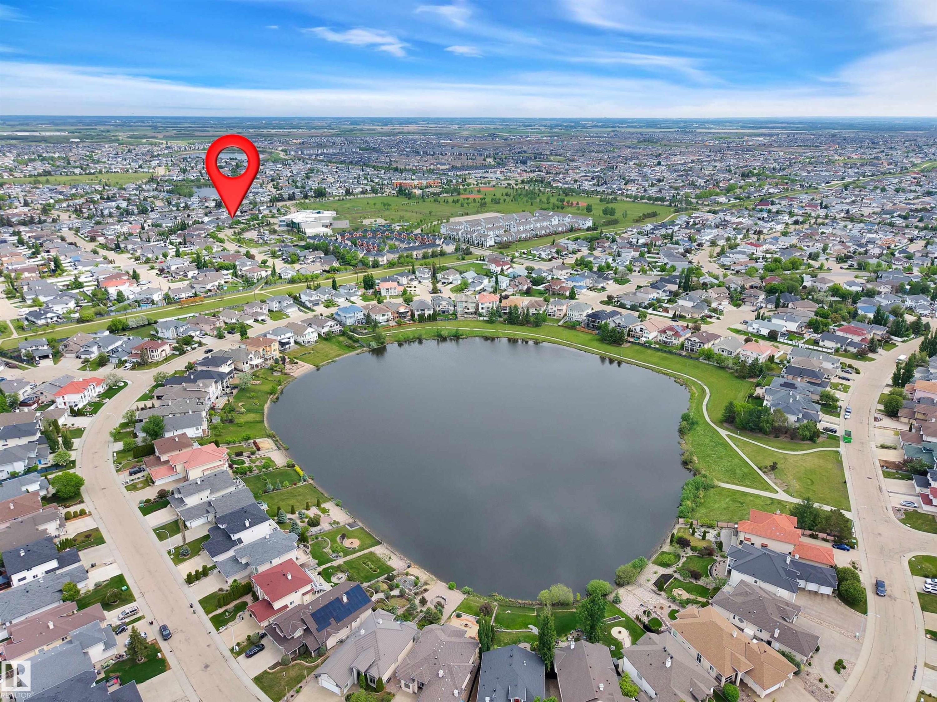 Aerial perspective showcasing a residential area with a prominent central lake - 16512 87 Street Nw, Edmonton, AB - Outdoor With Body Of Water With View