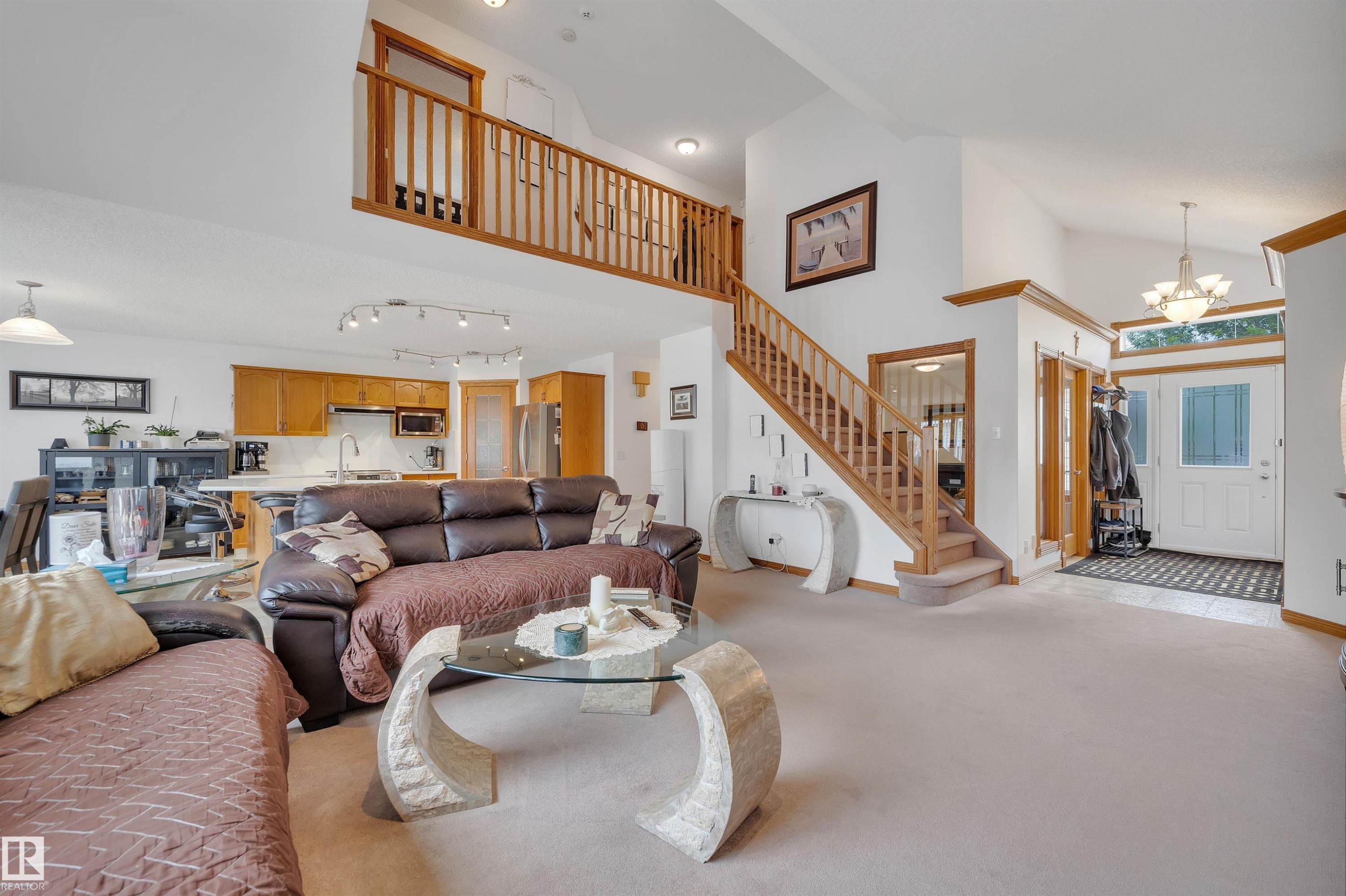 Expansive living area with high vaulted ceilings and light-toned carpeting - 16512 87 Street Nw, Edmonton, AB - Indoor Photo Showing Living Room