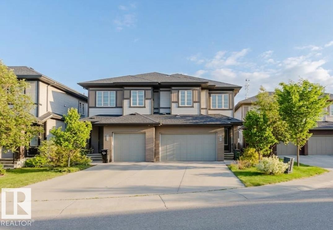 Duplex property featuring modern architectural elements and a dark shingle roof - 2921 Anderson Crest Sw, Edmonton, AB - Outdoor With Facade