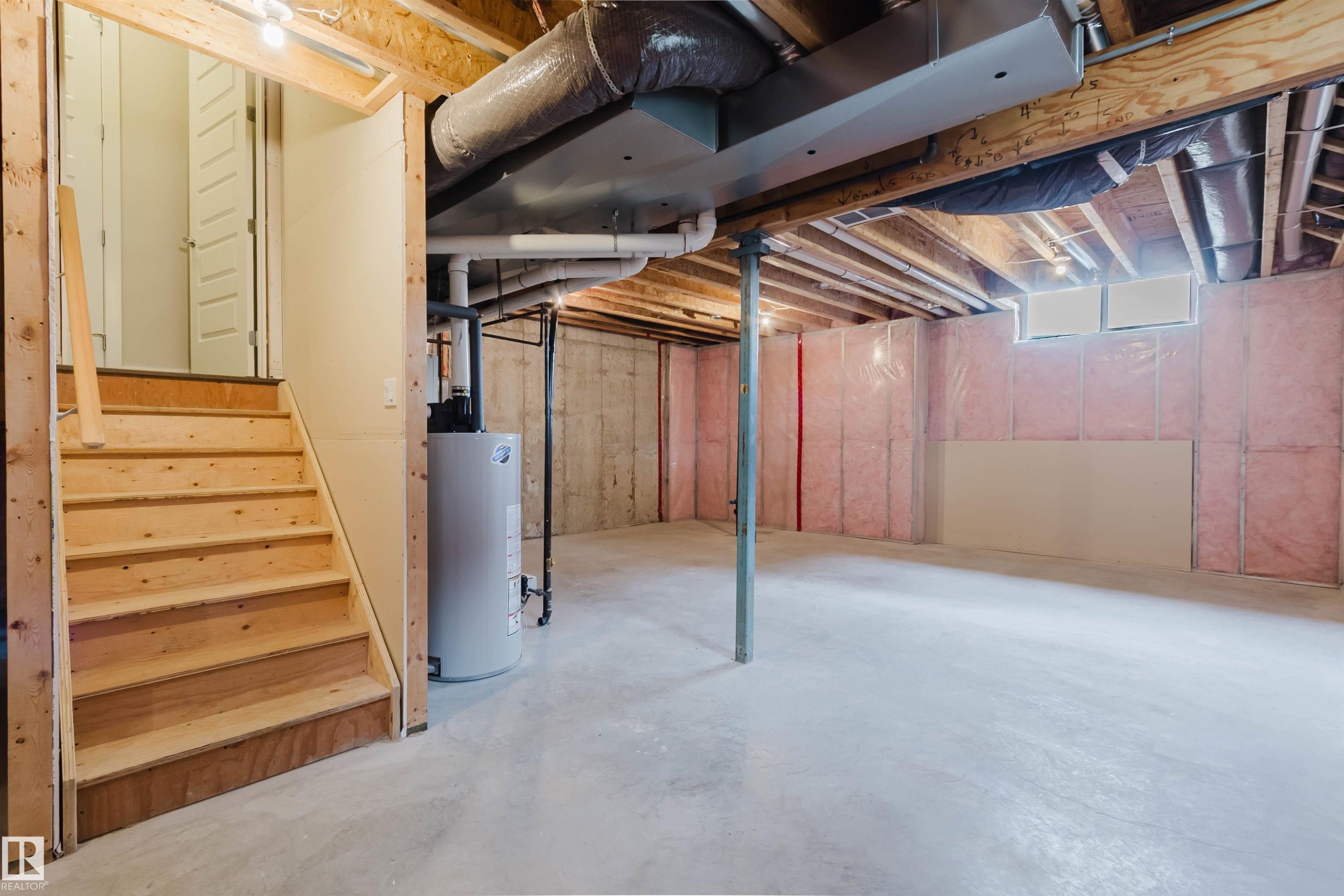 Unfinished basement with concrete flooring and exposed ceiling joists - 2921 Anderson Crest Sw, Edmonton, AB - Indoor Photo Showing Basement