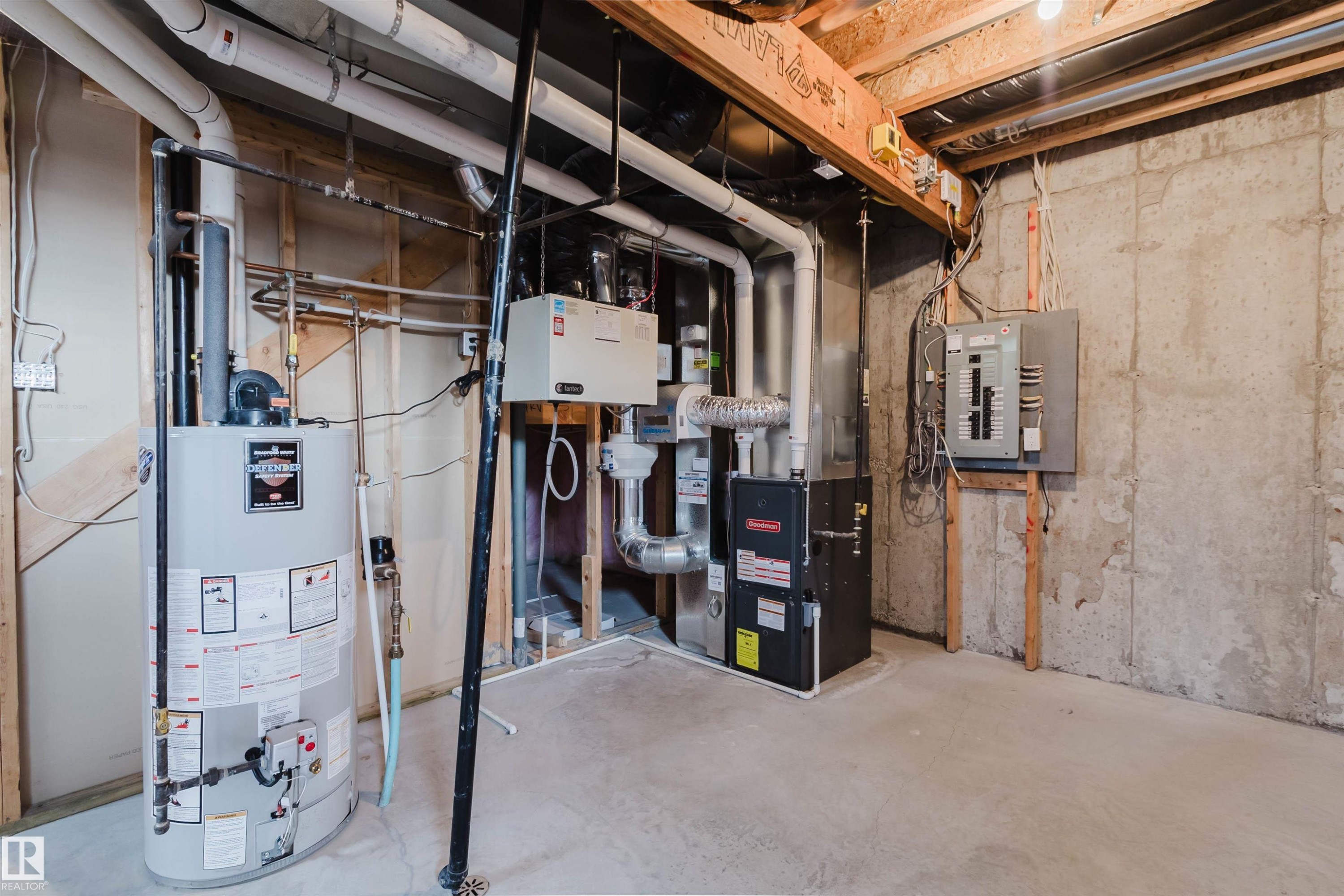 Utility room featuring a water heater, furnace, electrical panel, and exposed concrete walls - 2921 Anderson Crest Sw, Edmonton, AB - Indoor Photo Showing Basement