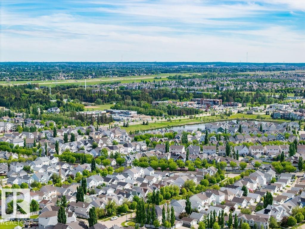 Aerial perspective showcasing a residential community with varied architectural styles and mature landscaping - 71 3040 Spence Wynd, Edmonton, AB