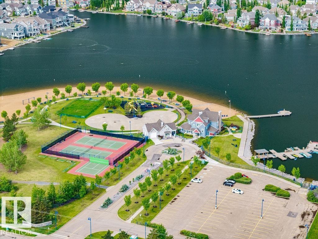 Lakeside community with multiple tennis courts, recreational green space, sandy beach area, and private boat docks - 71 3040 Spence Wynd, Edmonton, AB