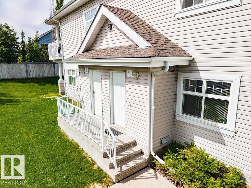 Exterior featuring horizontal siding, white trim, and a shingled roof - 71 3040 Spence Wynd, Edmonton, AB