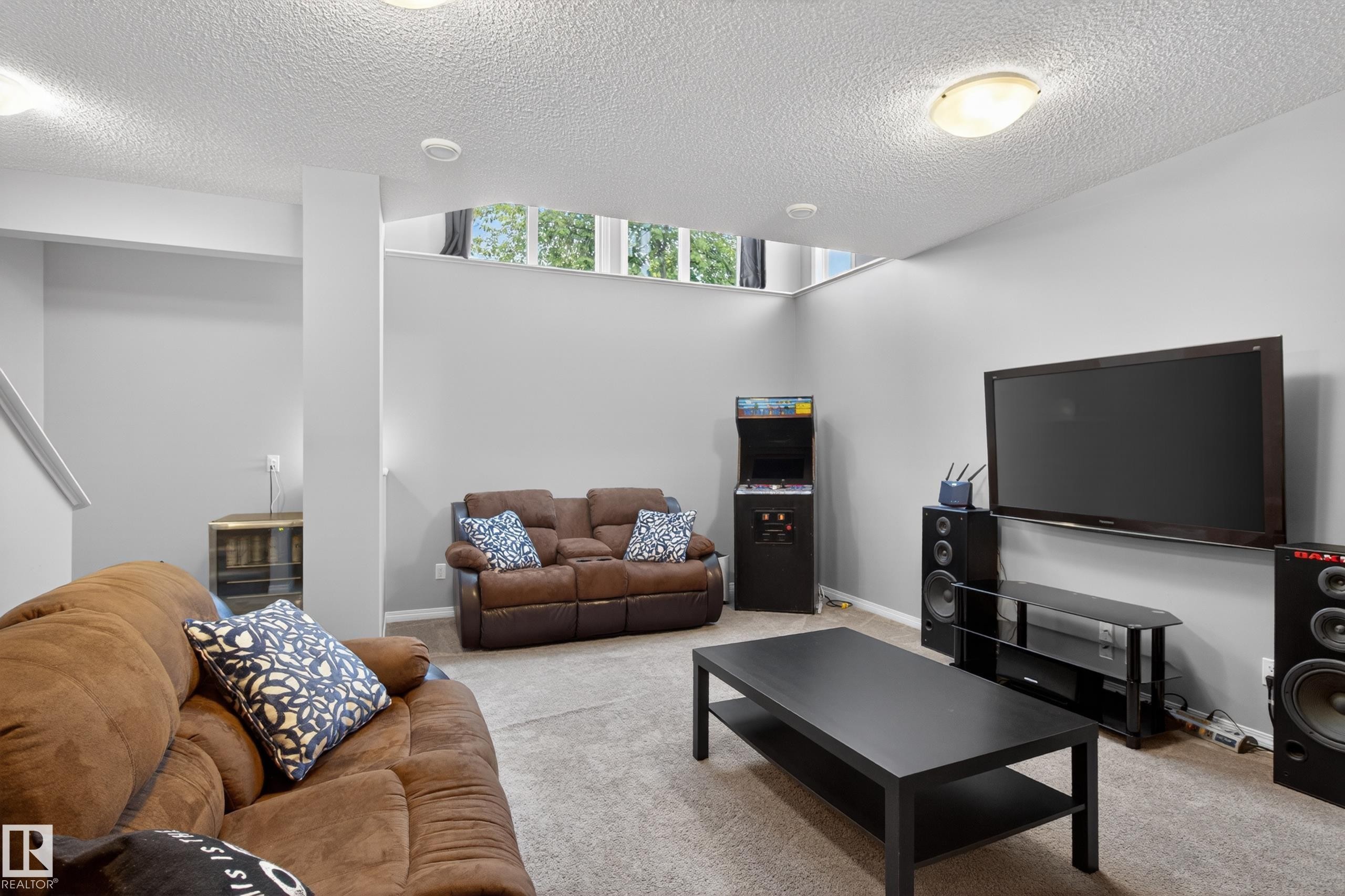 Finished basement living area featuring carpet flooring, recessed lighting, and high-set windows - 9847 220 Street, Edmonton, AB