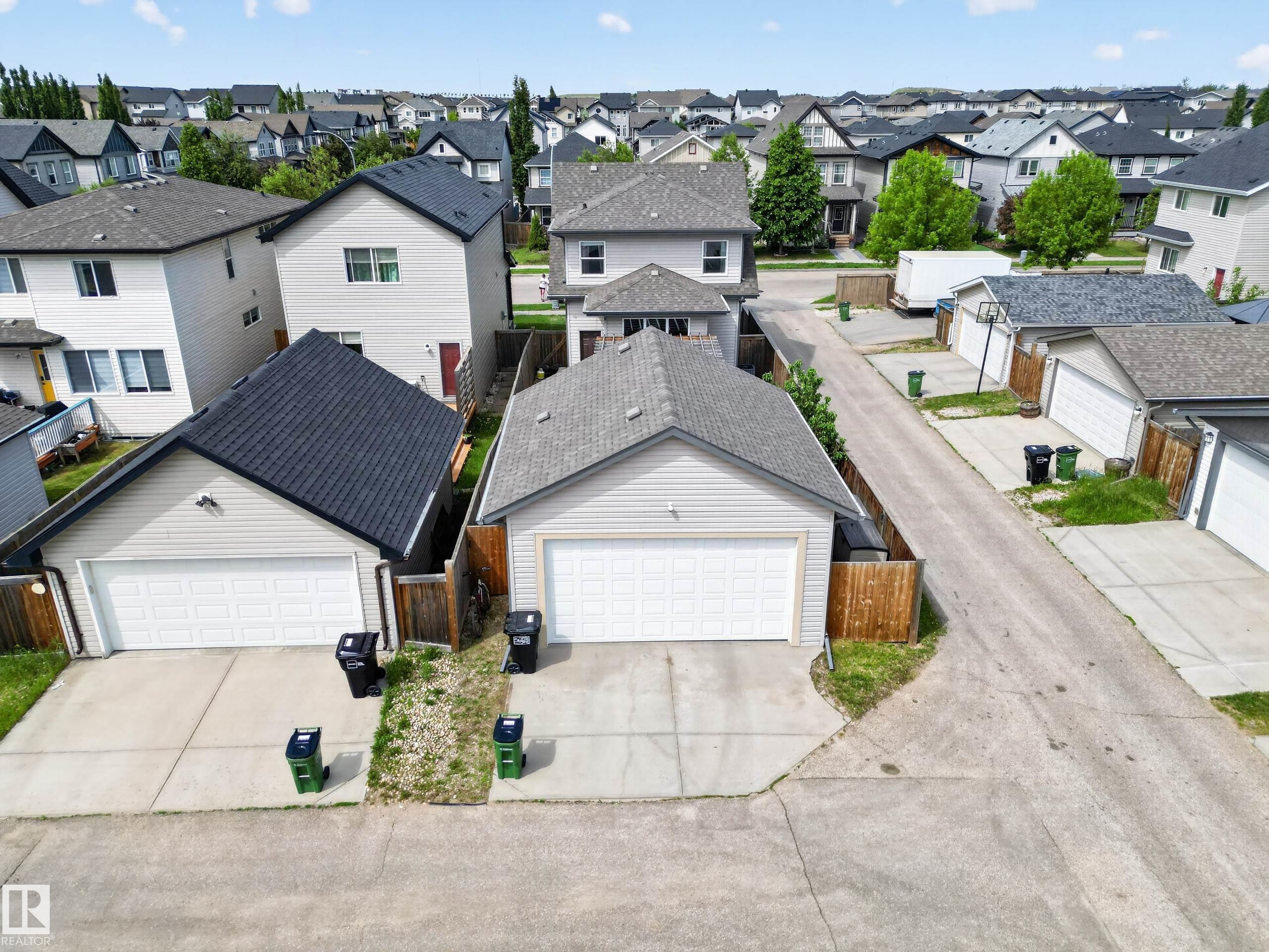Detached garage with light-colored siding and a dark shingle roof - 9847 220 Street, Edmonton, AB