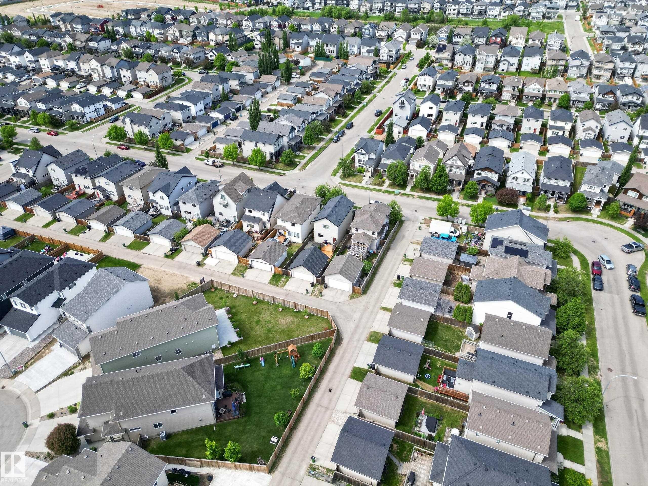 Aerial perspective showcasing a residential development with numerous single-family homes - 9847 220 Street, Edmonton, AB