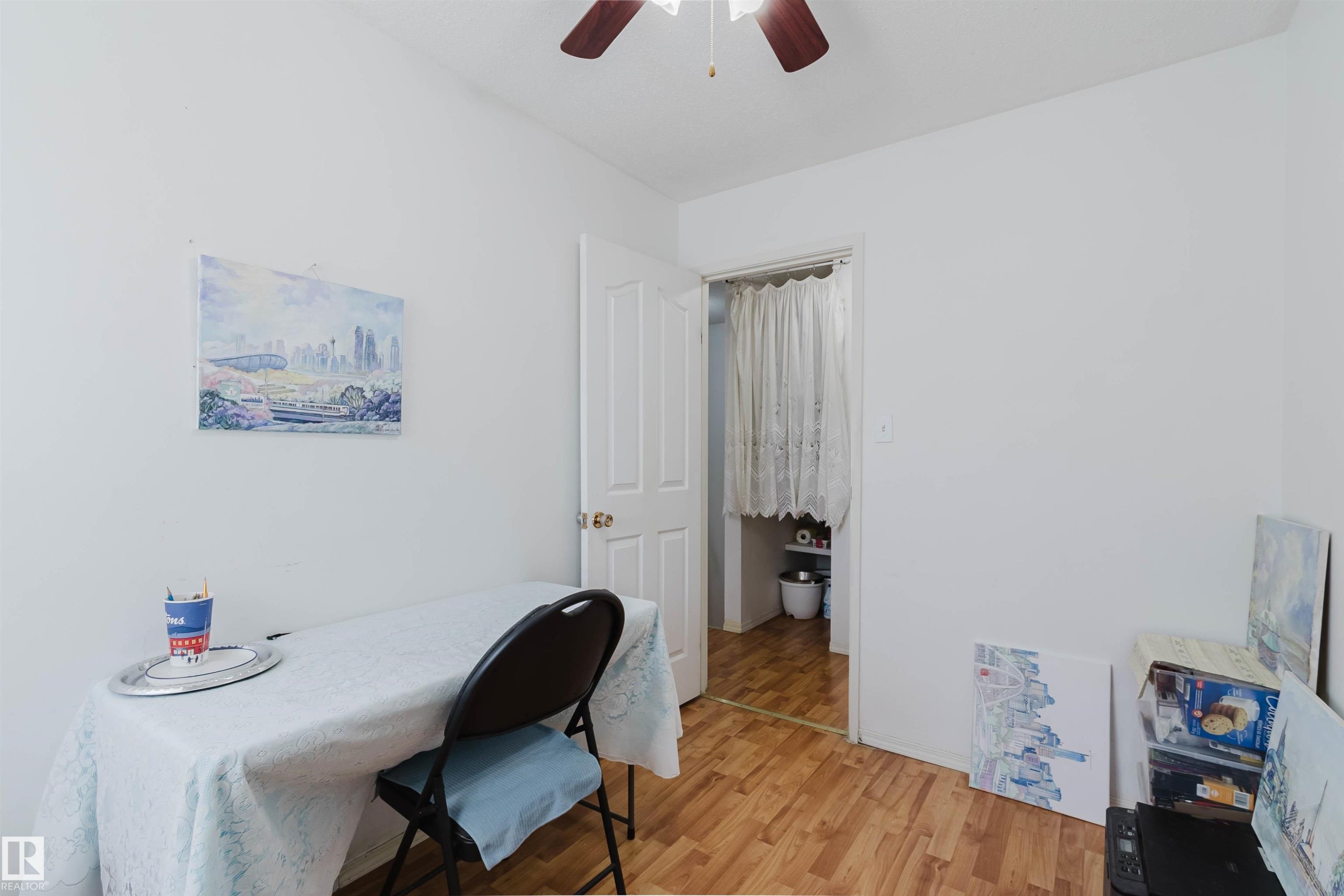 White walls featuring wood-finish flooring and a ceiling fan - 4 14310 80 Street, Edmonton, AB