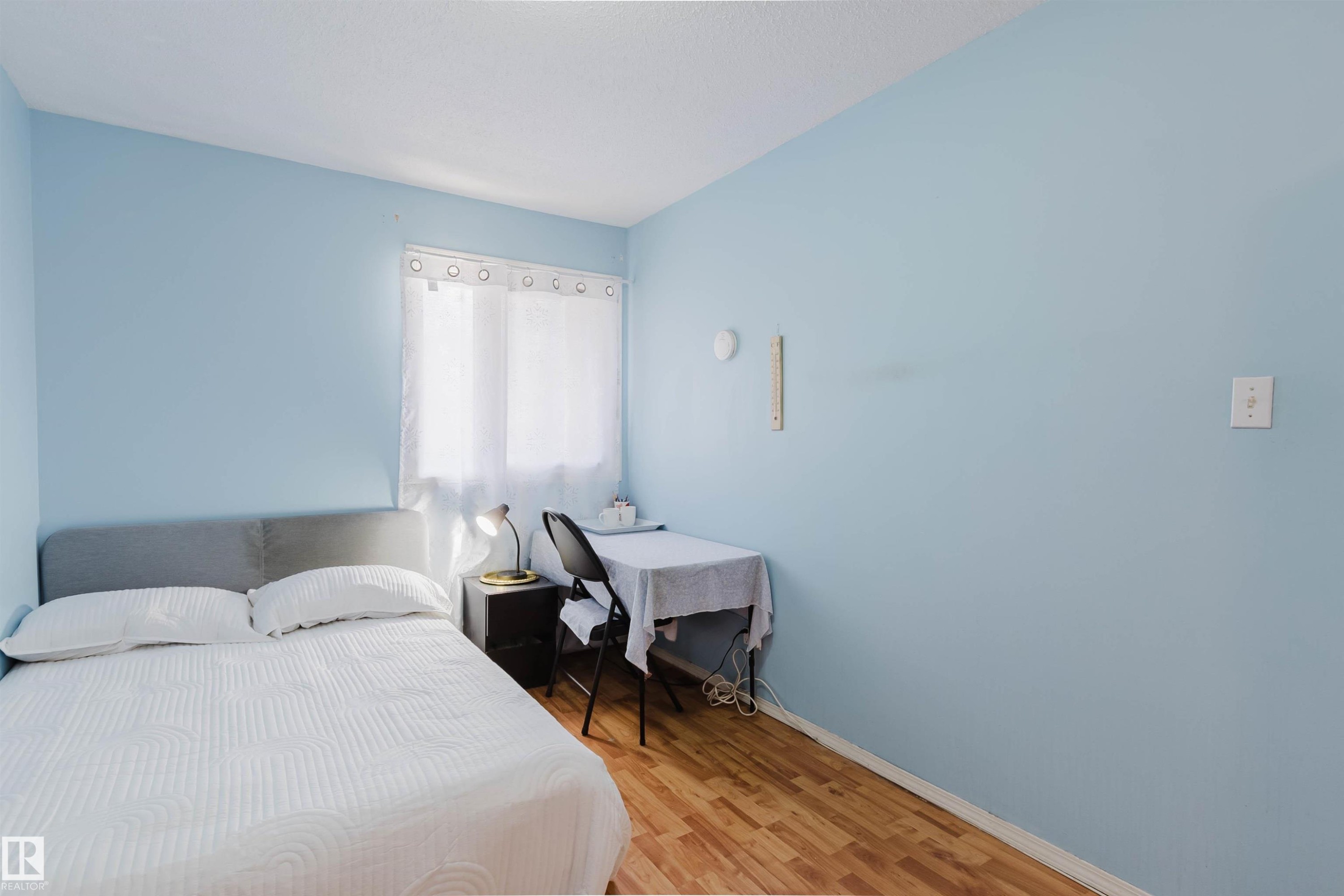 Light blue painted walls with wood-finish flooring - 4 14310 80 Street, Edmonton, AB