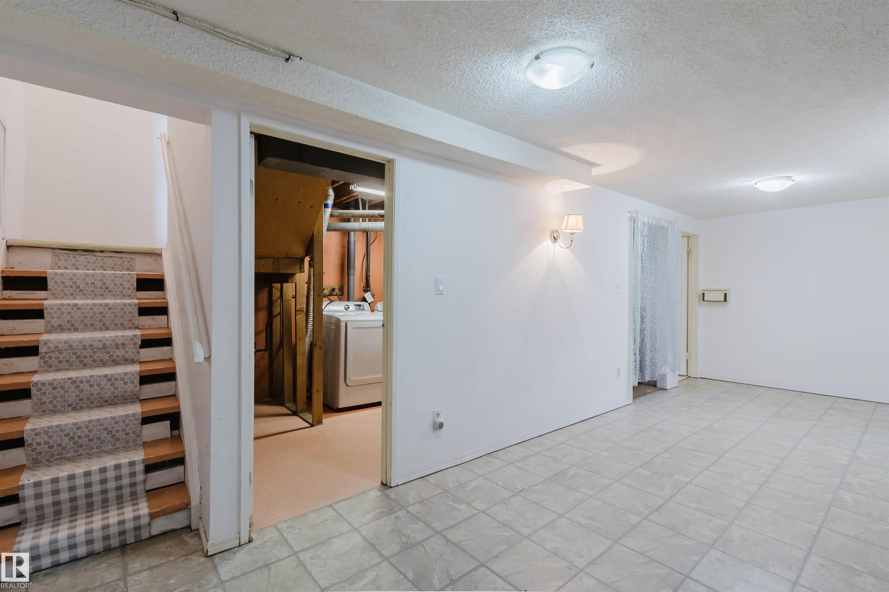 Finished interior space featuring light-toned square tile flooring - 4 14310 80 Street, Edmonton, AB