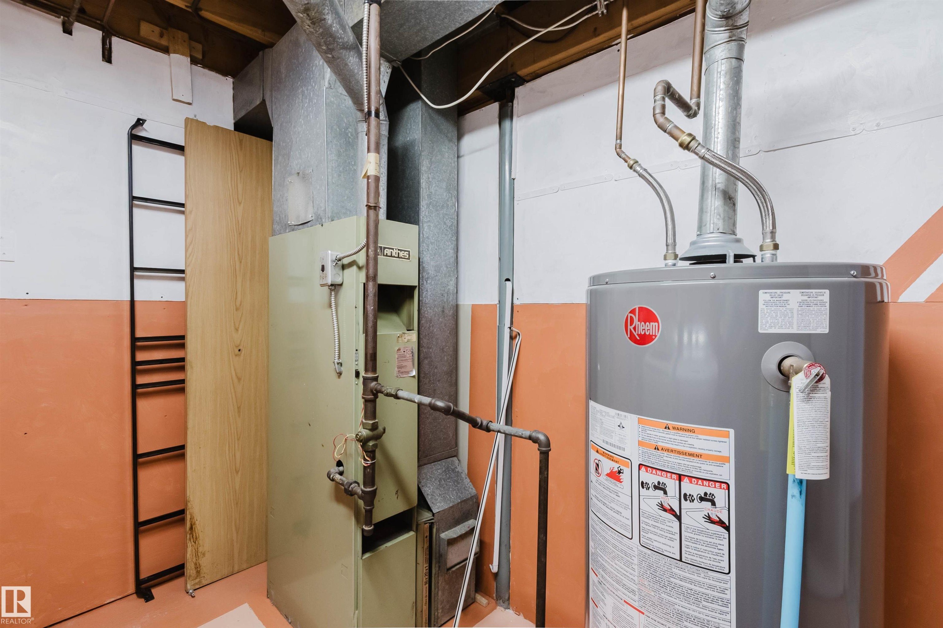 Utility space featuring a water heater, furnace, exposed ductwork, and copper piping - 4 14310 80 Street, Edmonton, AB