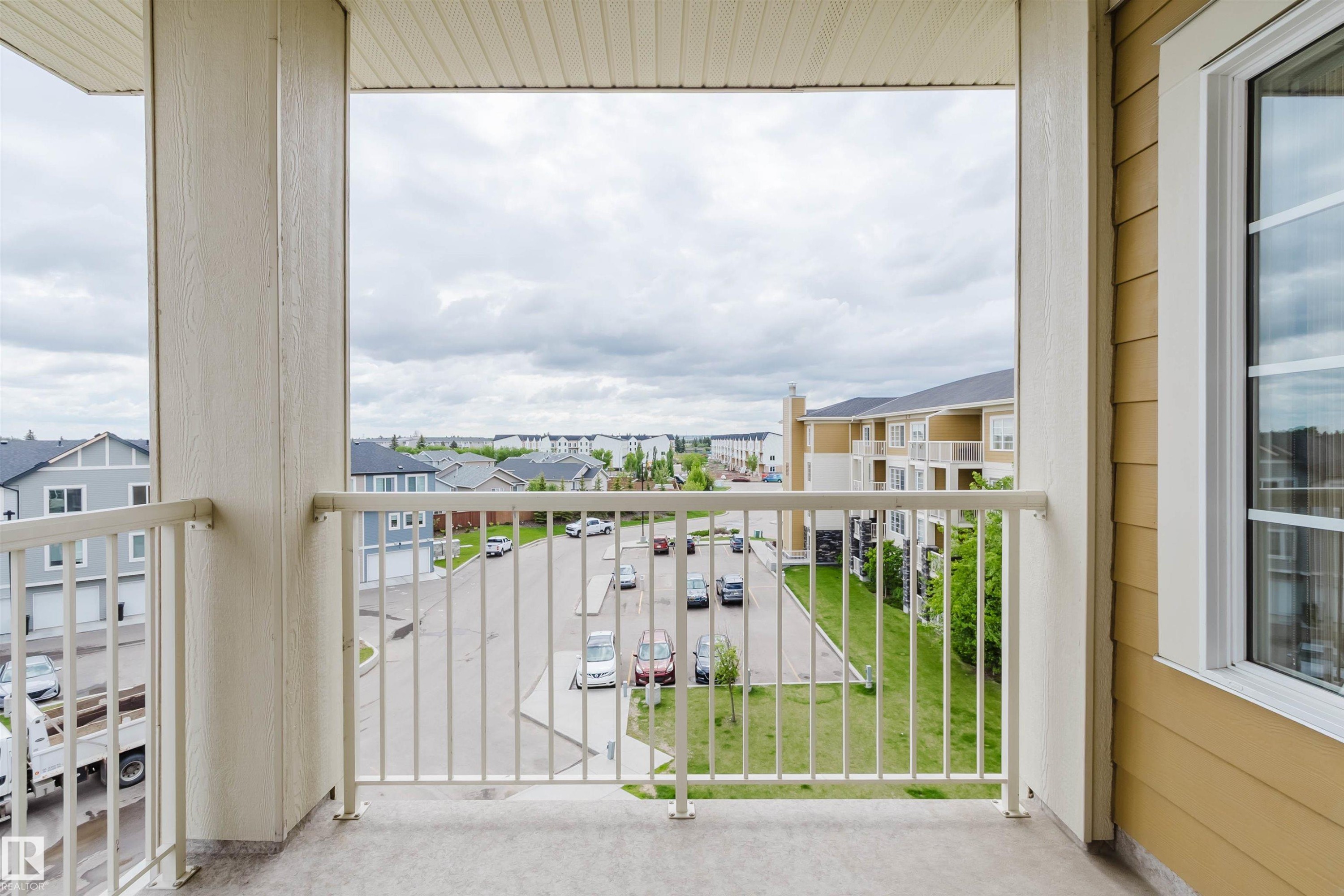 Private balcony featuring a concrete floor and white metal railing - 402 3670 139 Avenue, Edmonton, AB