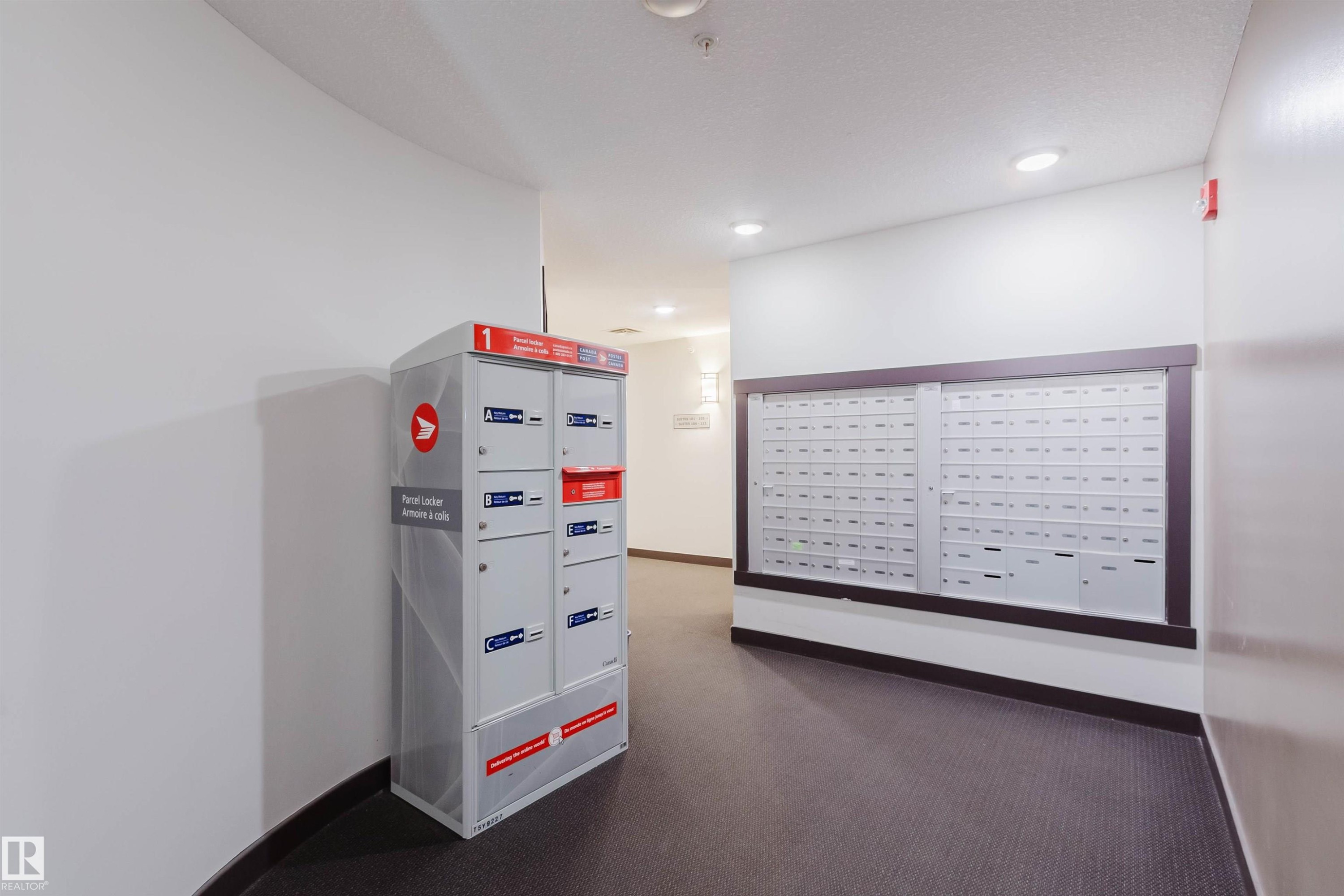 Interior mailroom featuring individual mailboxes and parcel lockers - 402 3670 139 Avenue, Edmonton, AB